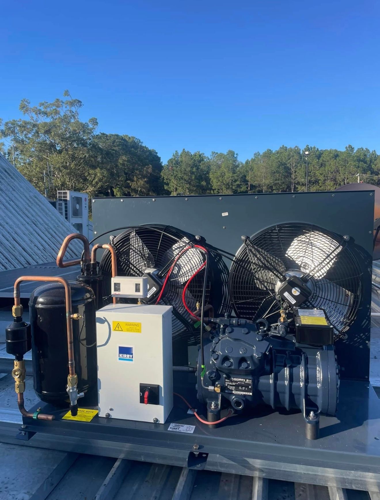 Outdoor industrial equipment on a flatbed truck, with large fans, compressors, and pipes under blue sky — Deltech HVACR in Georgetown, NSW