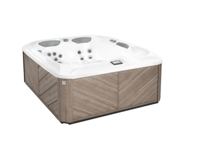 Hot tub with gray wood paneling and white interior, angled view.