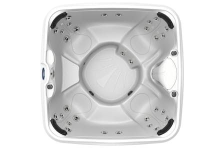 Overhead view of a white, square hot tub with multiple seating areas and jets.