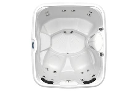 Top-down view of a white square hot tub with contoured seating, several jet nozzles, and control panel.