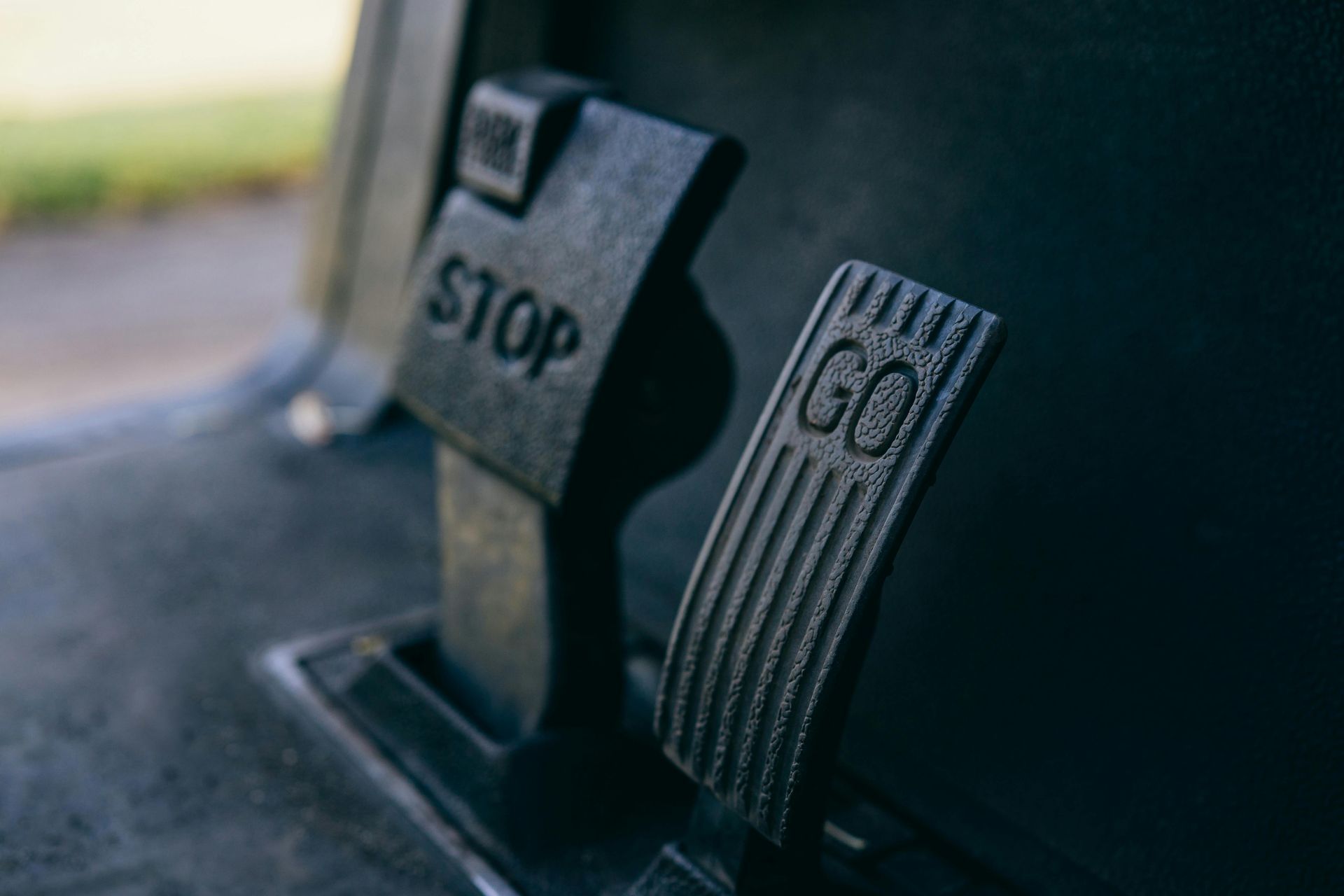 A close up of a stop and go pedal on a car.