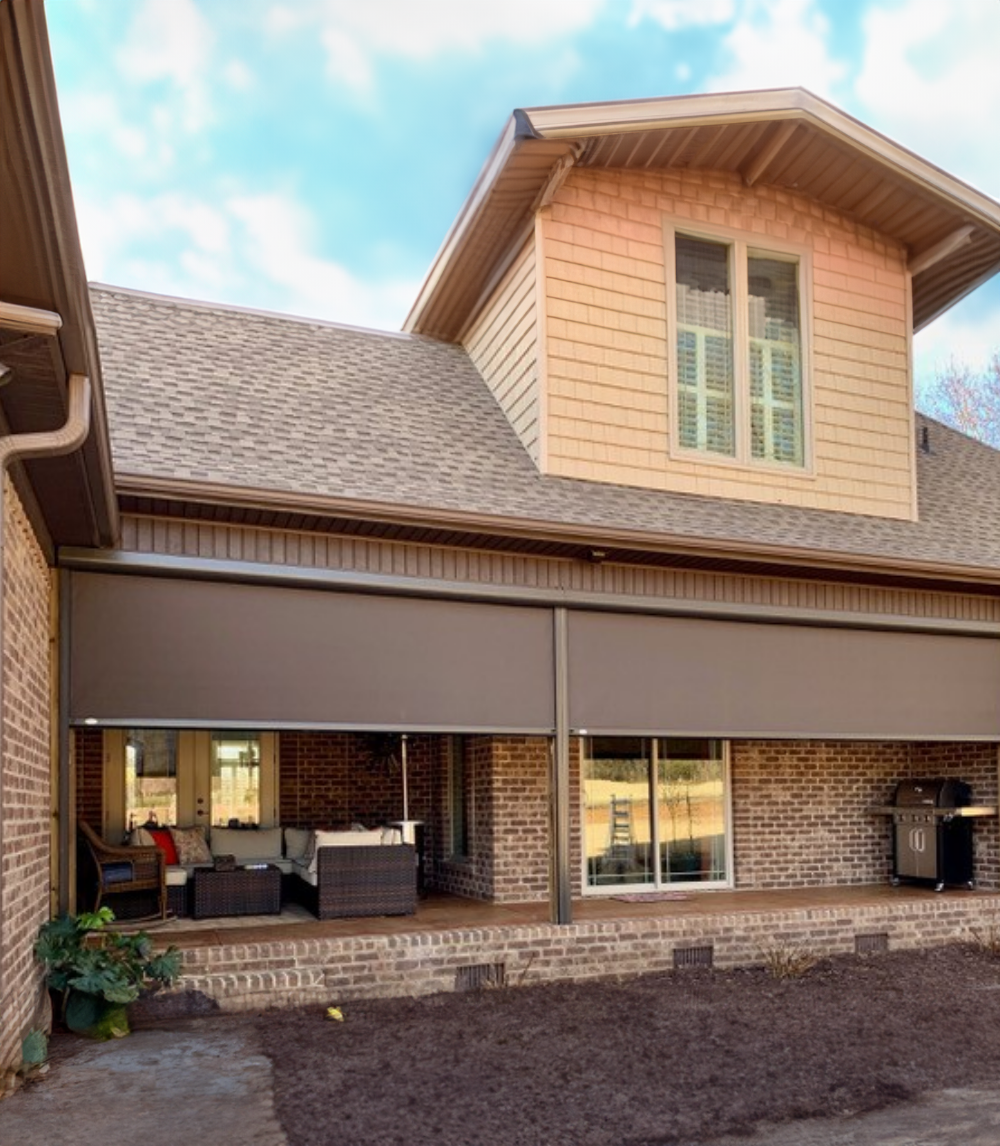 A large house with motorized patio screen