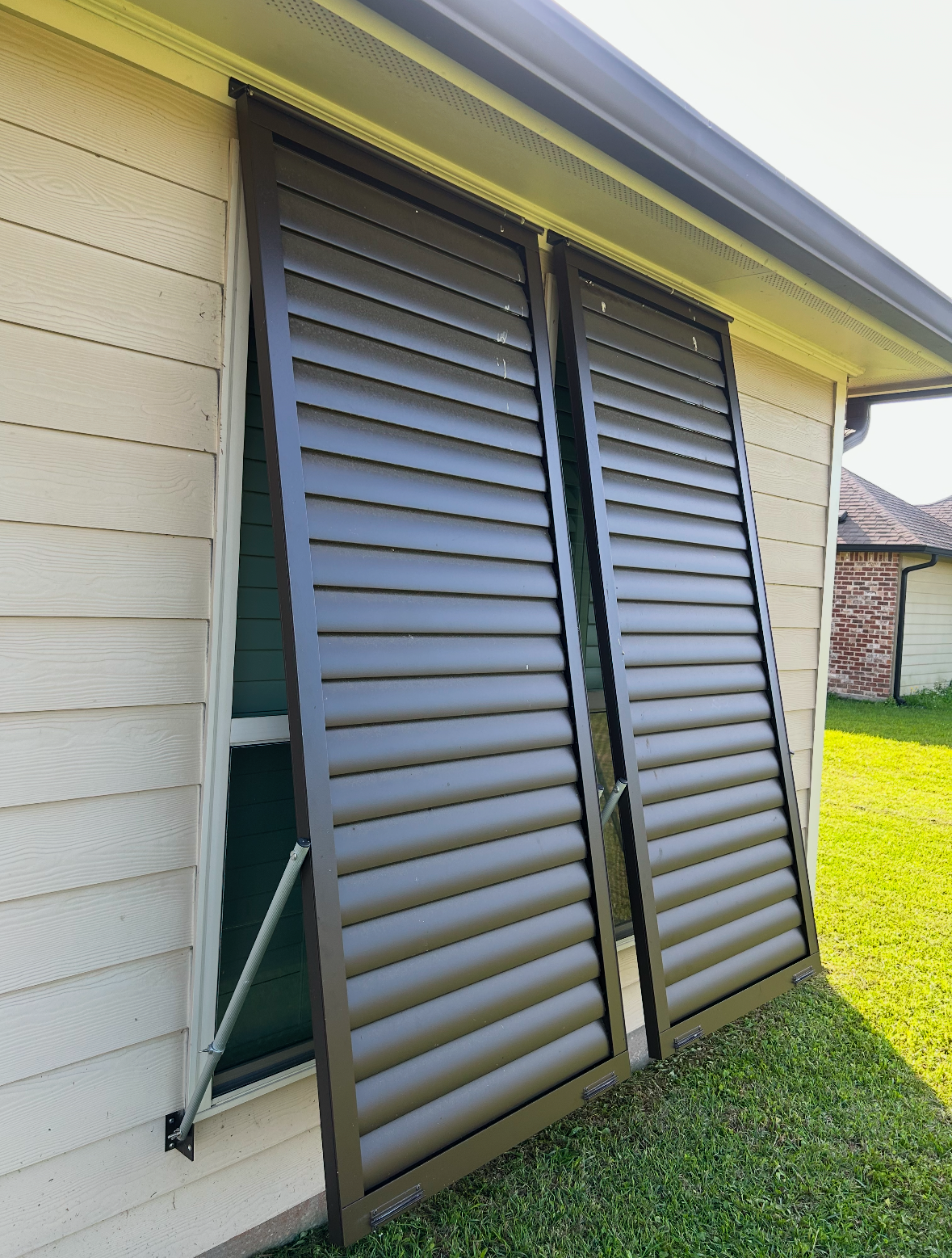 A house with a pair of shutters on the side of it