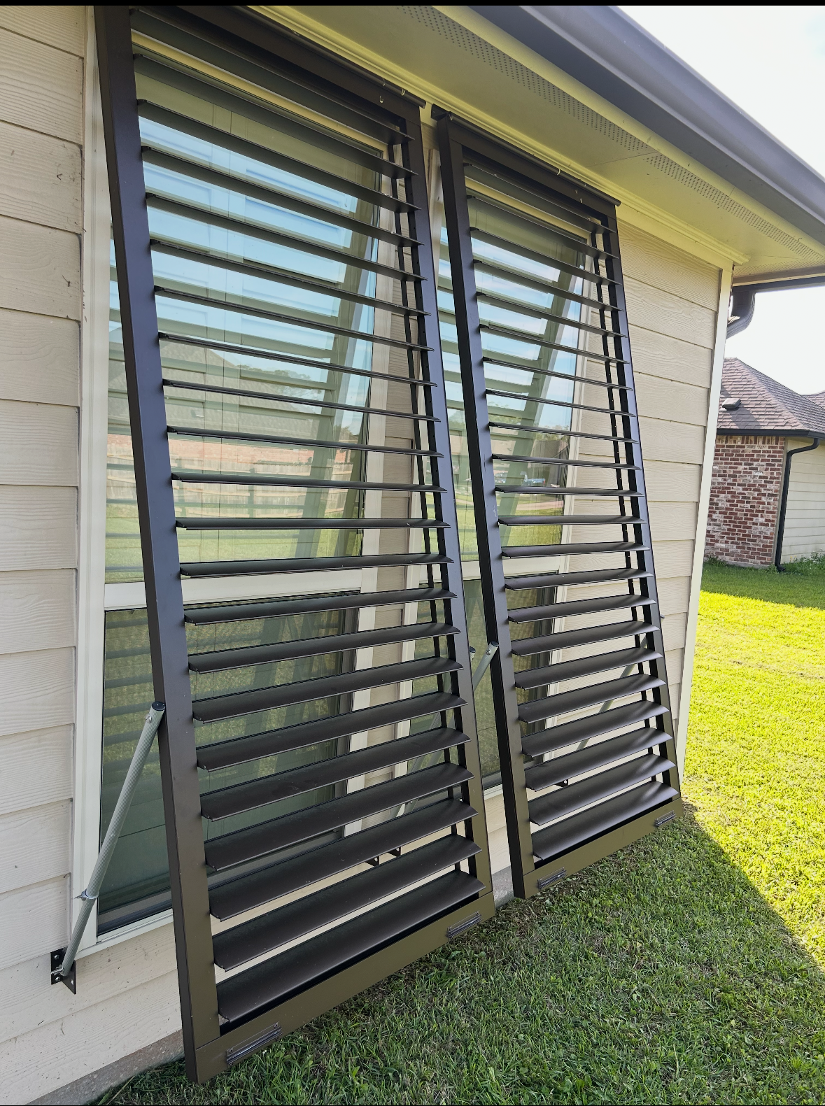 A pair of sliding glass doors with shutters
