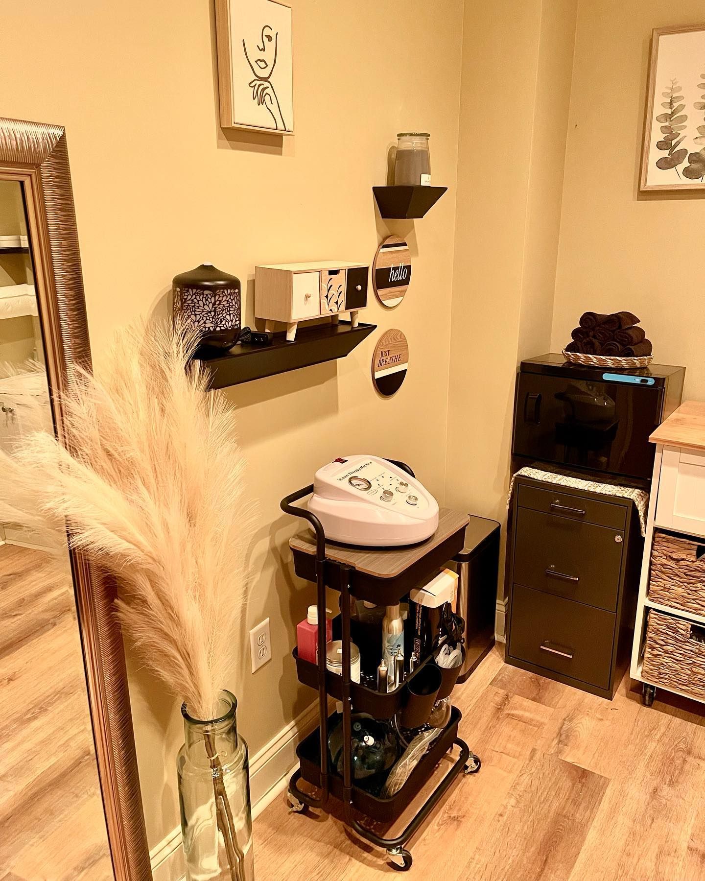 A room with a cart and a mirror on the wall.