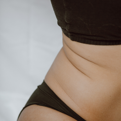 A womans body wearing a black bra and black underwear.