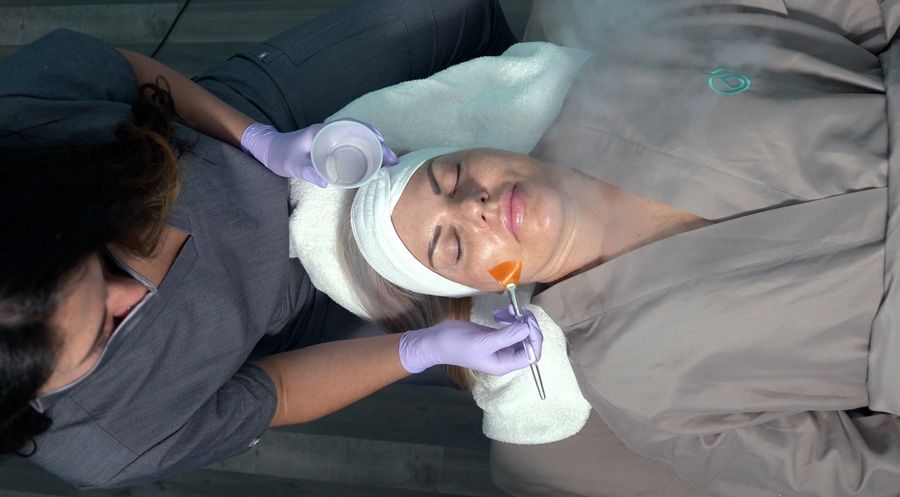 A woman is getting a facial treatment at a spa.