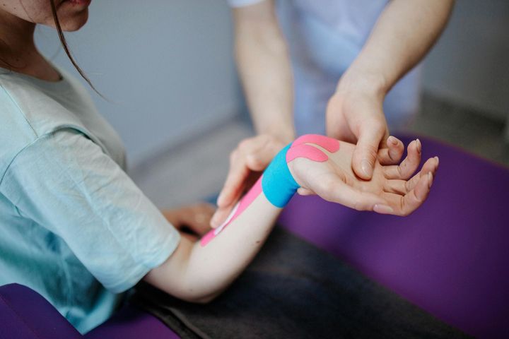 A woman is getting therapy on her wrist.