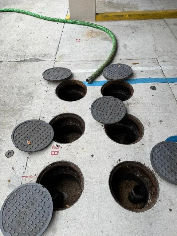 A bunch of manhole covers are laying on the ground