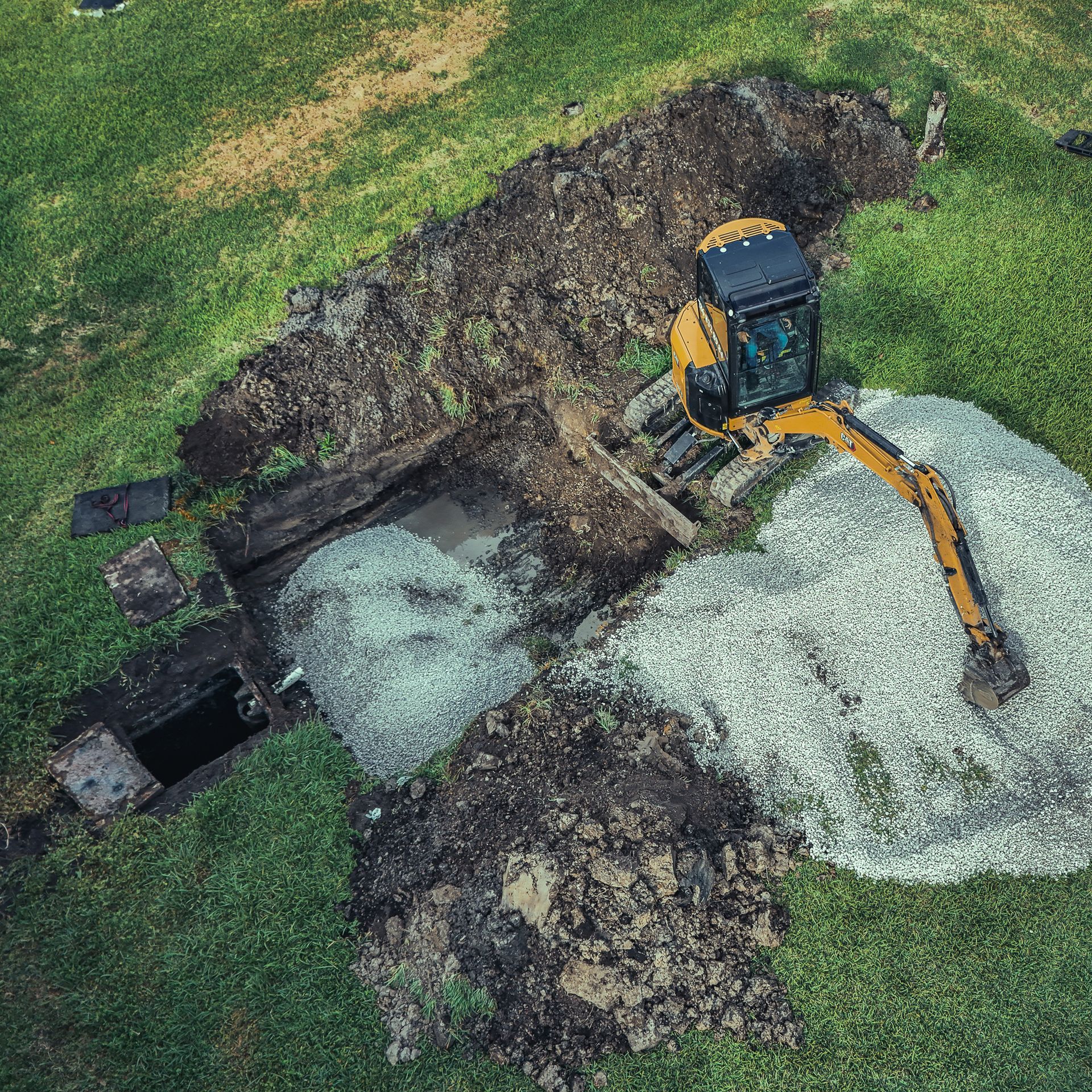 An aerial view of a bulldozer digging a hole in the ground.