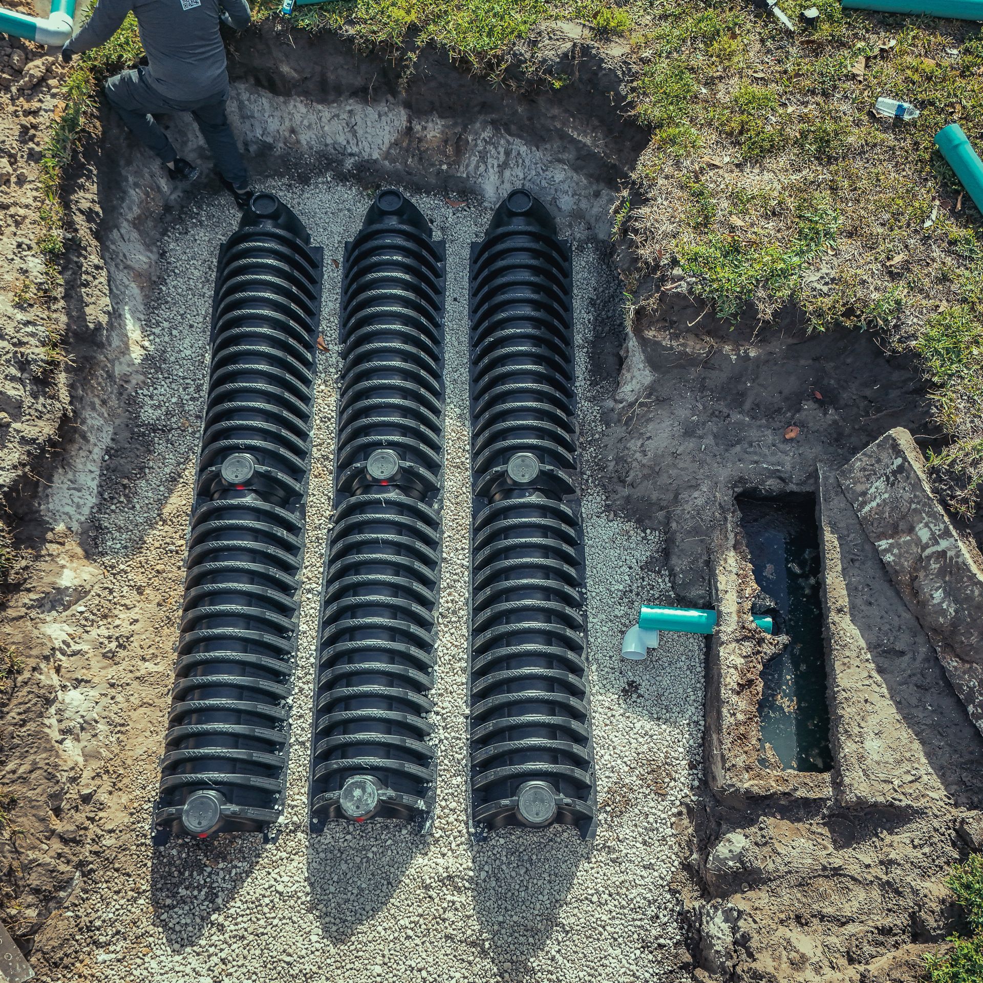 An aerial view of a septic system being installed in a yard.