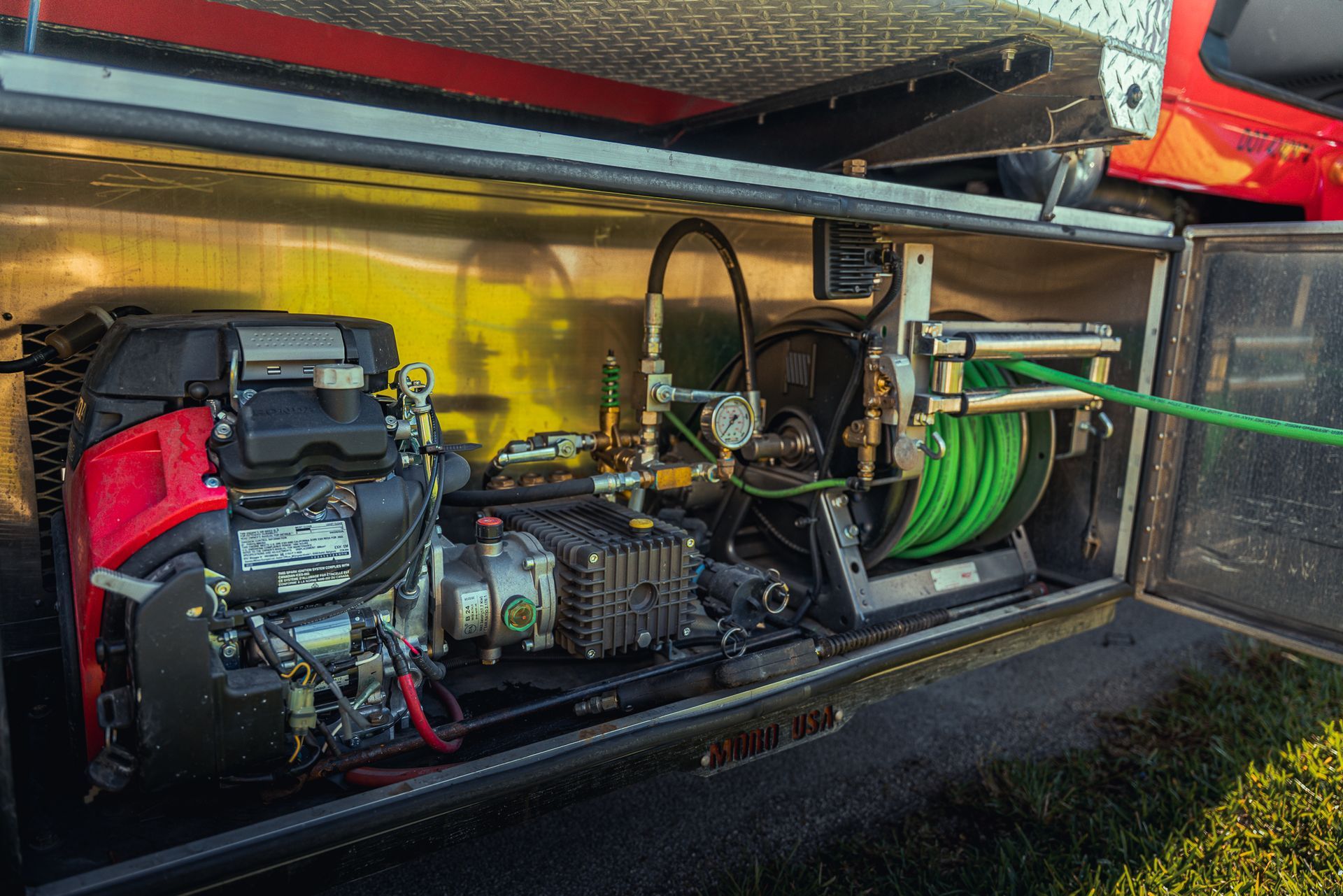 A hose is connected to a generator in the back of a truck.