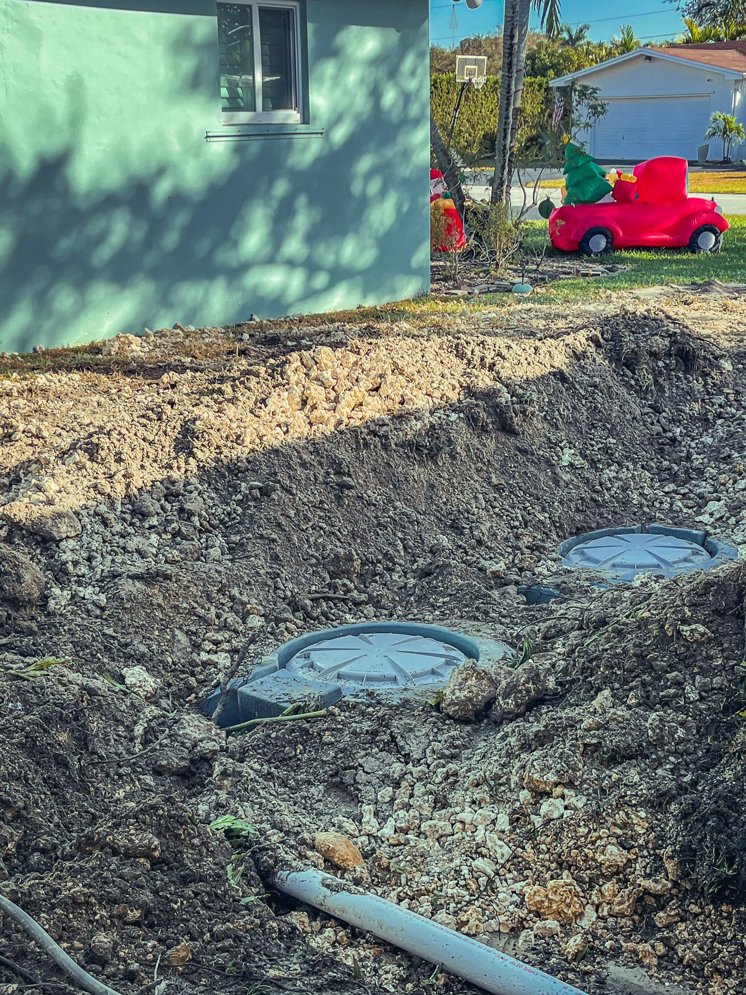 A red car is parked in front of a house.
