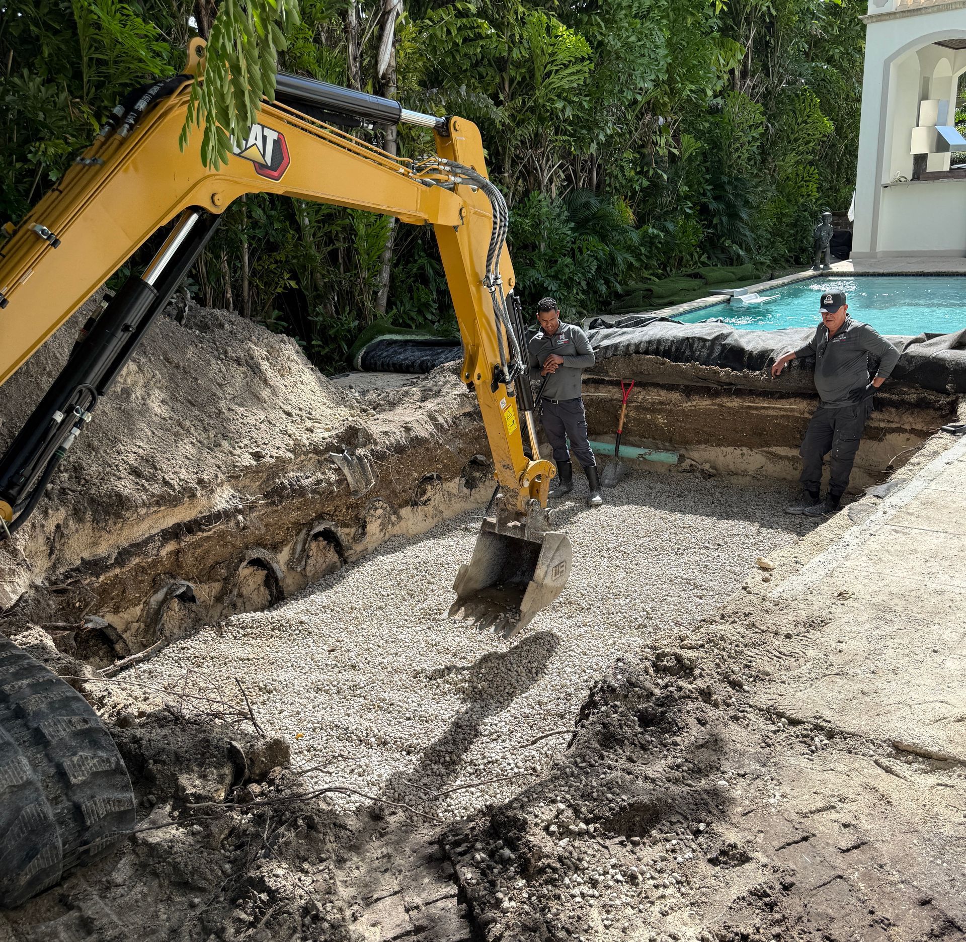 A close up of a hole in the ground with a rock in it.
