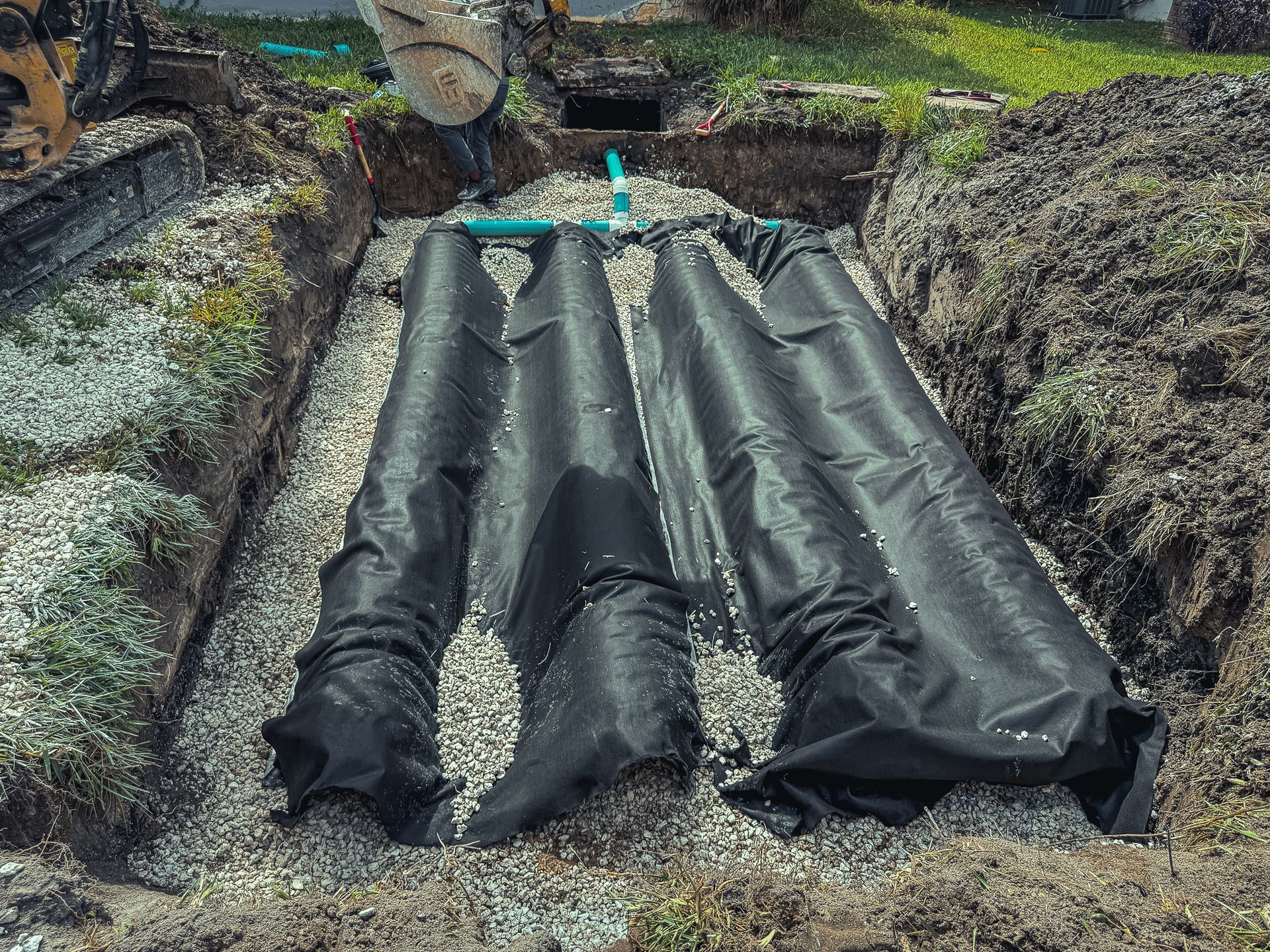 A septic system is being installed in a yard.
