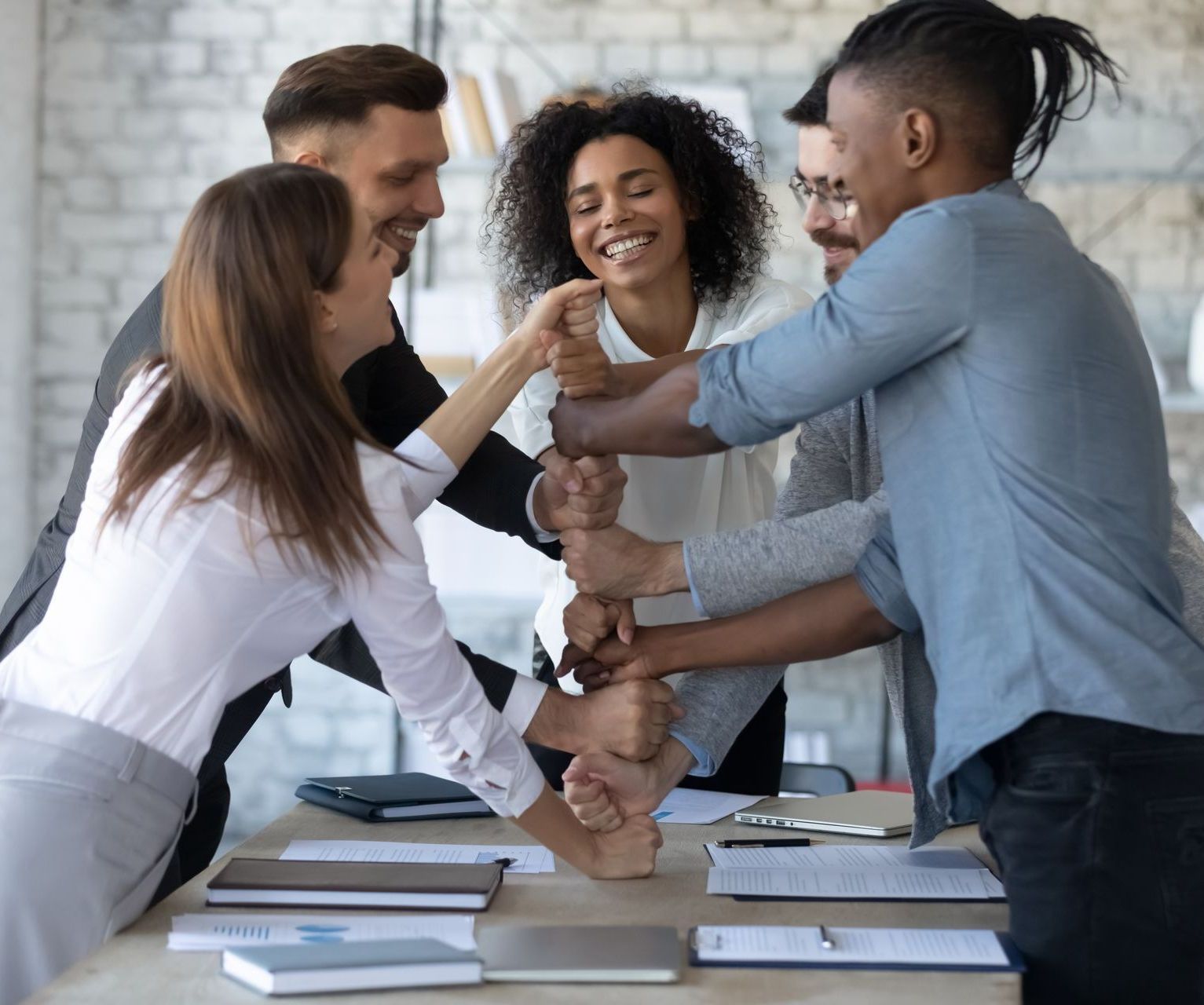 A man wearing a hard hat is standing in a kitchen with a drawing of the kitchen in the background.