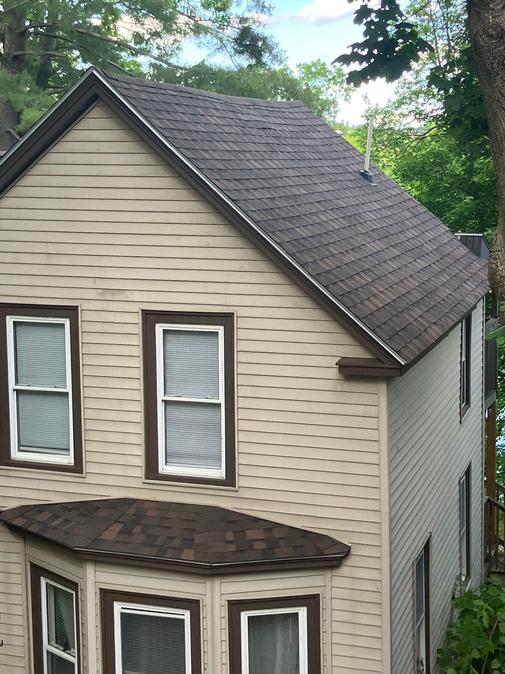 A house with a roof that has shingles on it