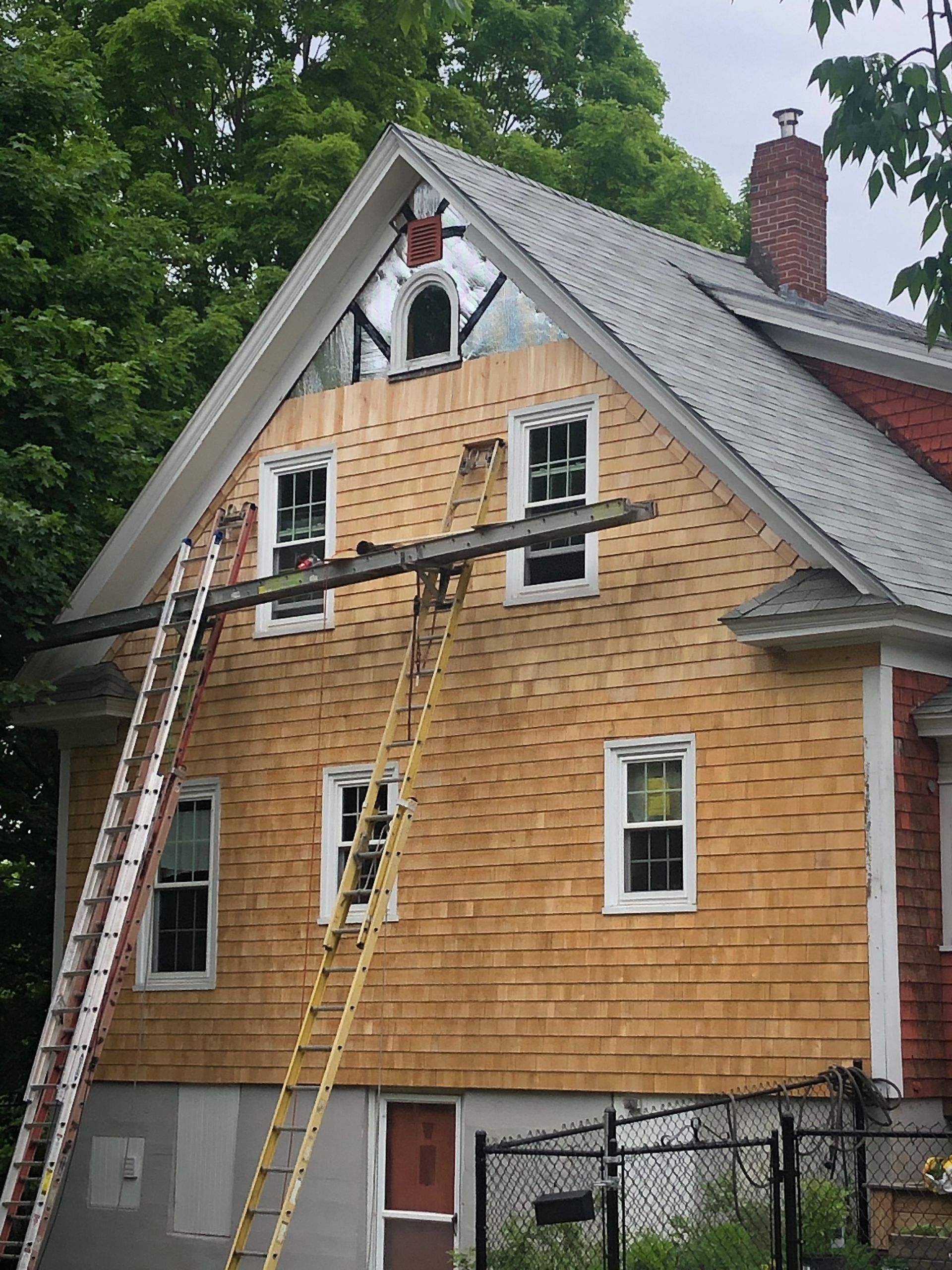A house with a ladder on the side of it