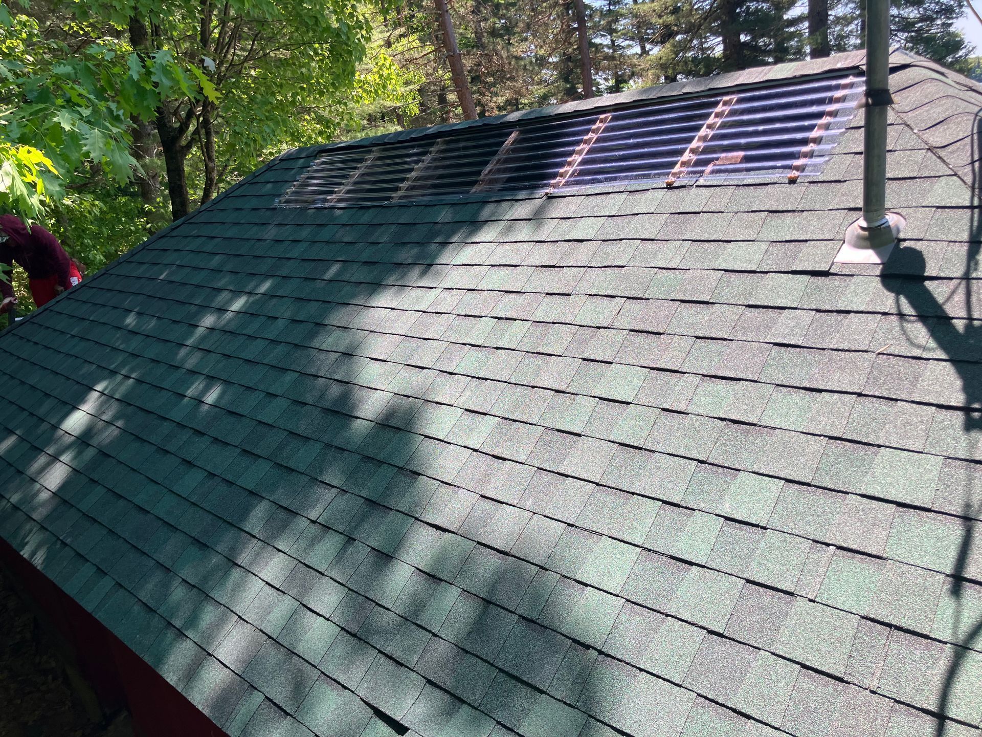 A green roof with a solar panel on top of it.
