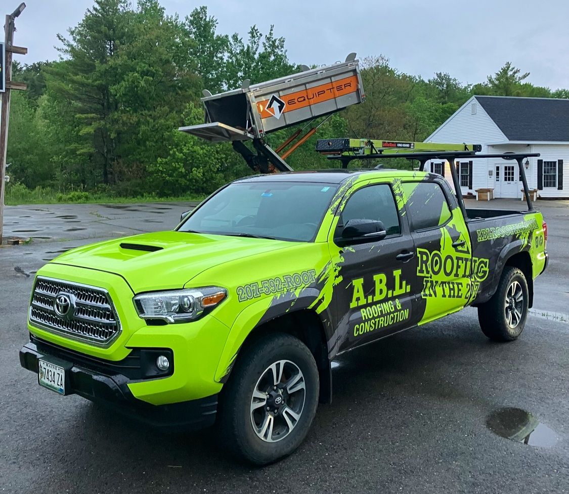 A yellow truck with the word roofing on it