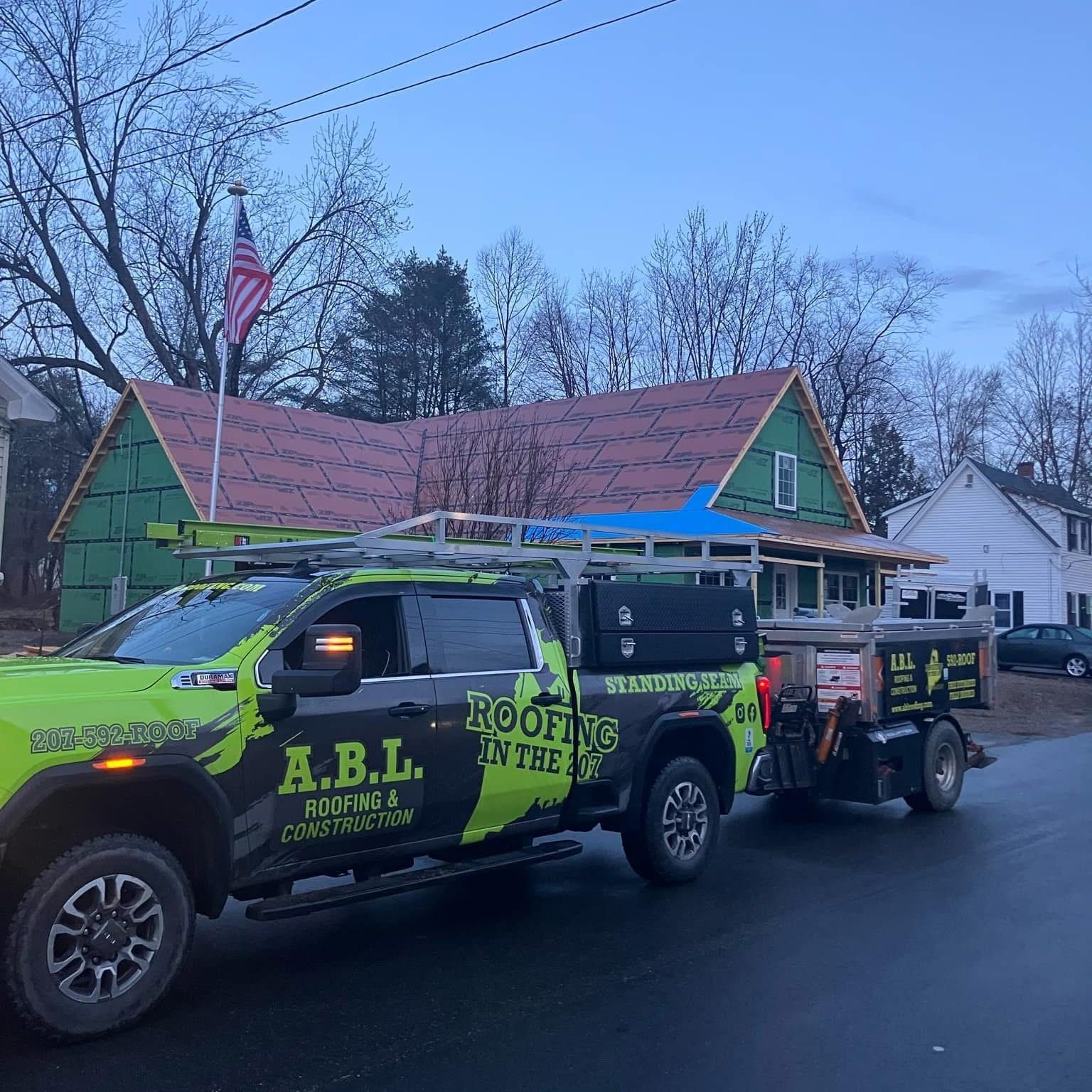 A truck with the word roofing on it