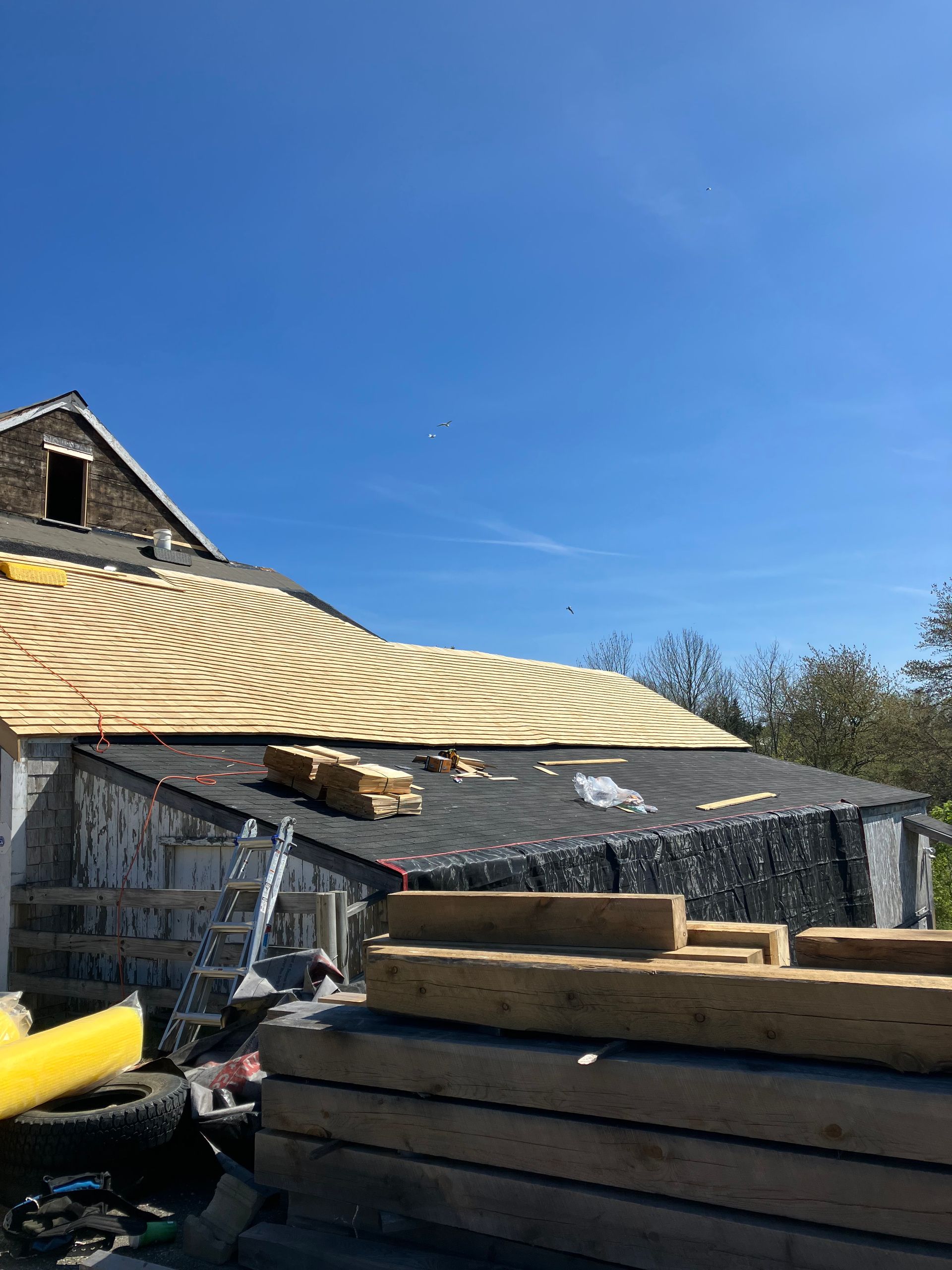 A wooden roof is being built on top of a house.
