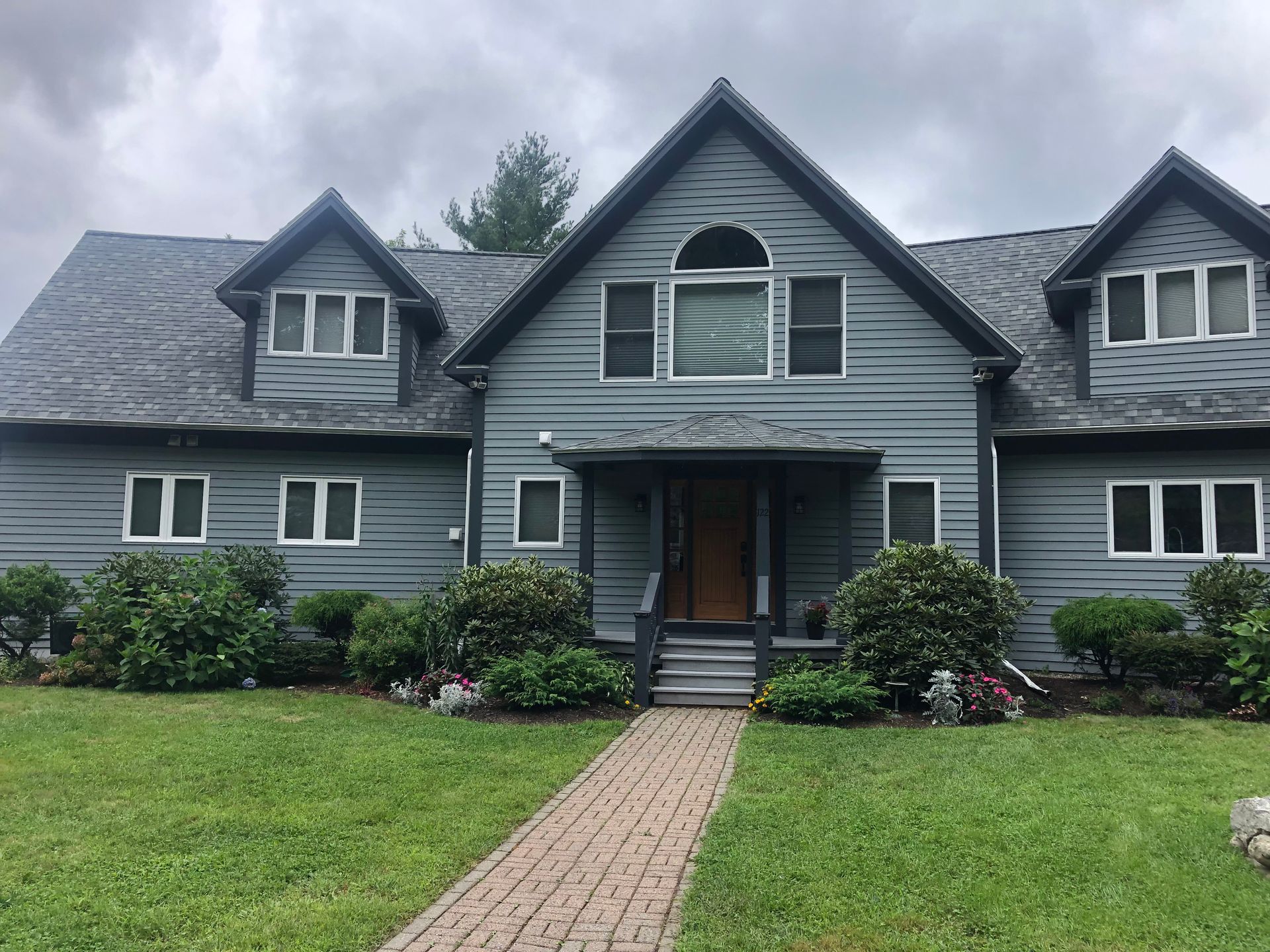A large house with a brick walkway leading to it