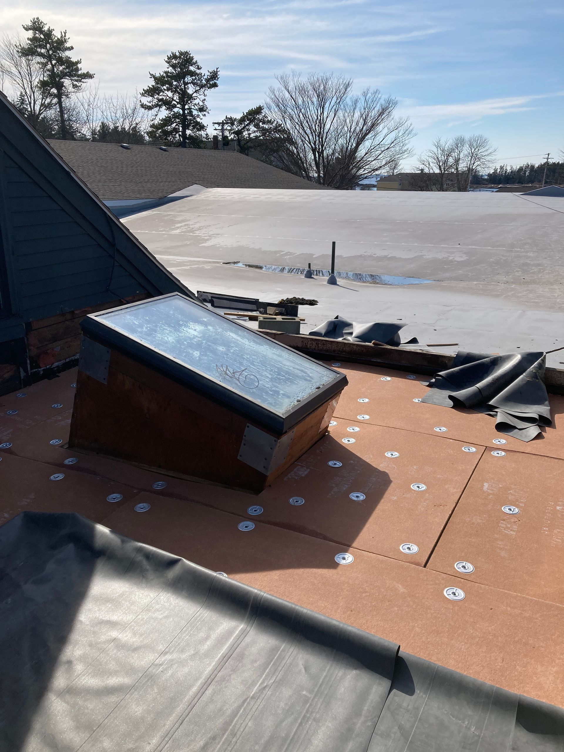 A roof with a skylight on top of it.