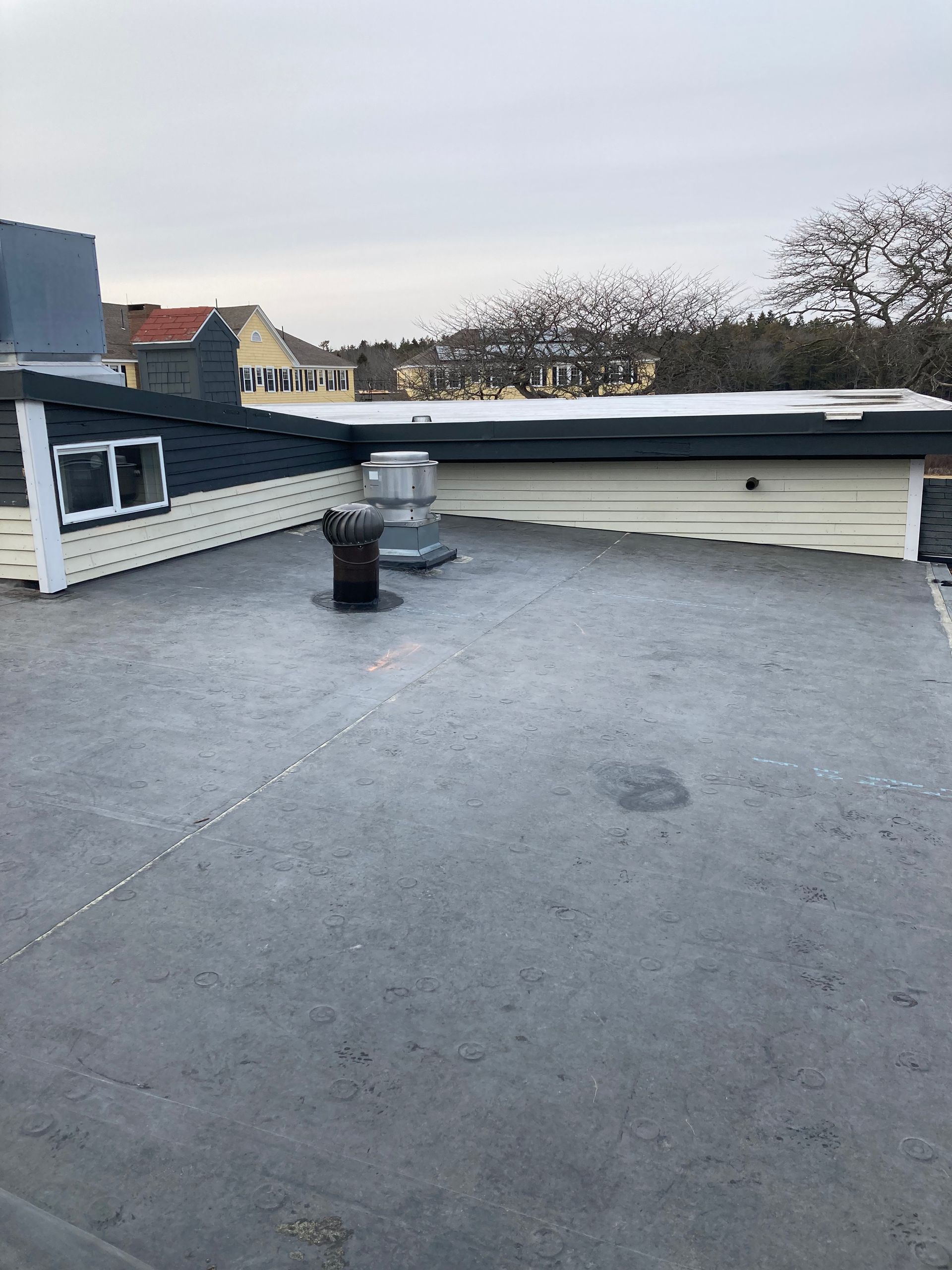 There is a chimney on the roof of a building.