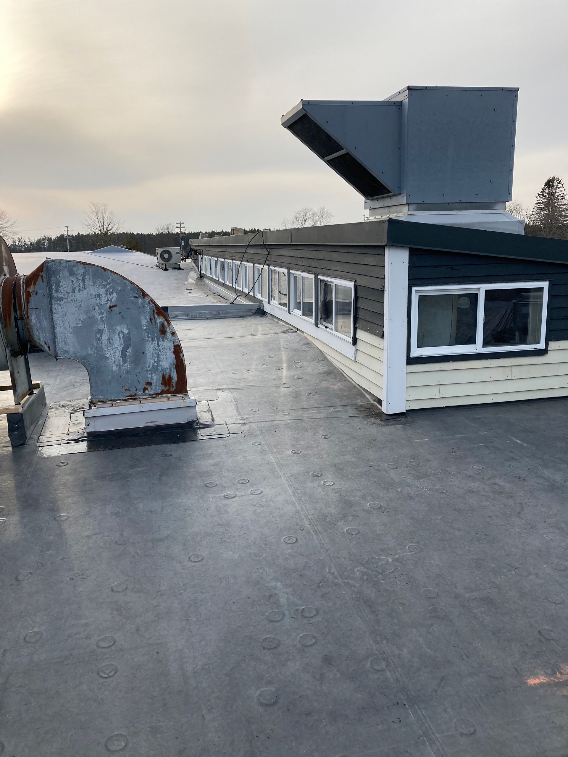 A rooftop view of a building with a lot of windows.