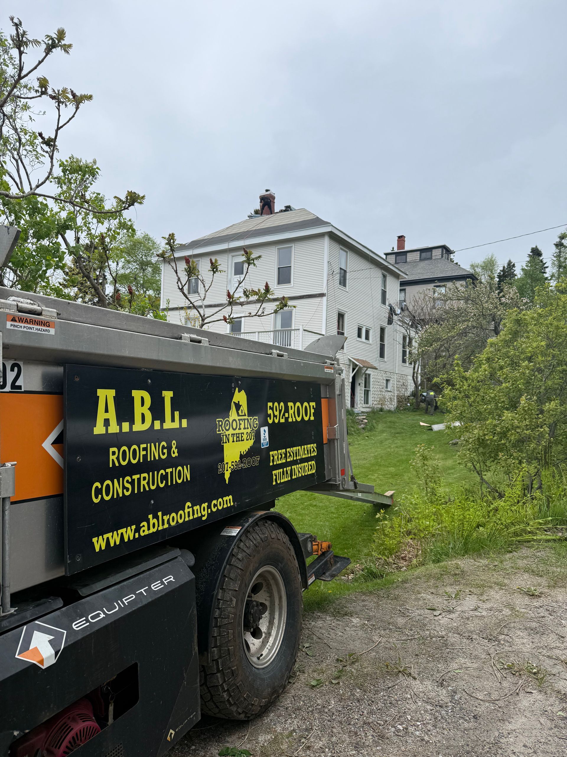 A dump truck is parked in front of a house.
