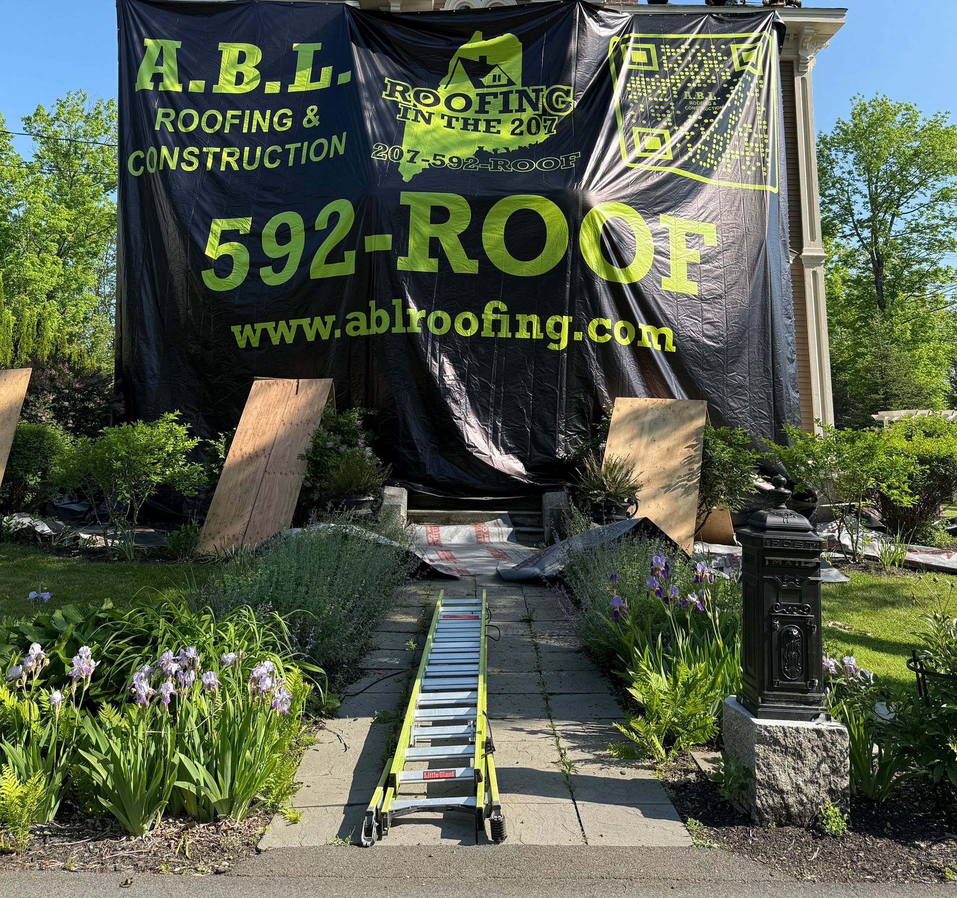 A ladder sits in front of a sign that says 592-roof