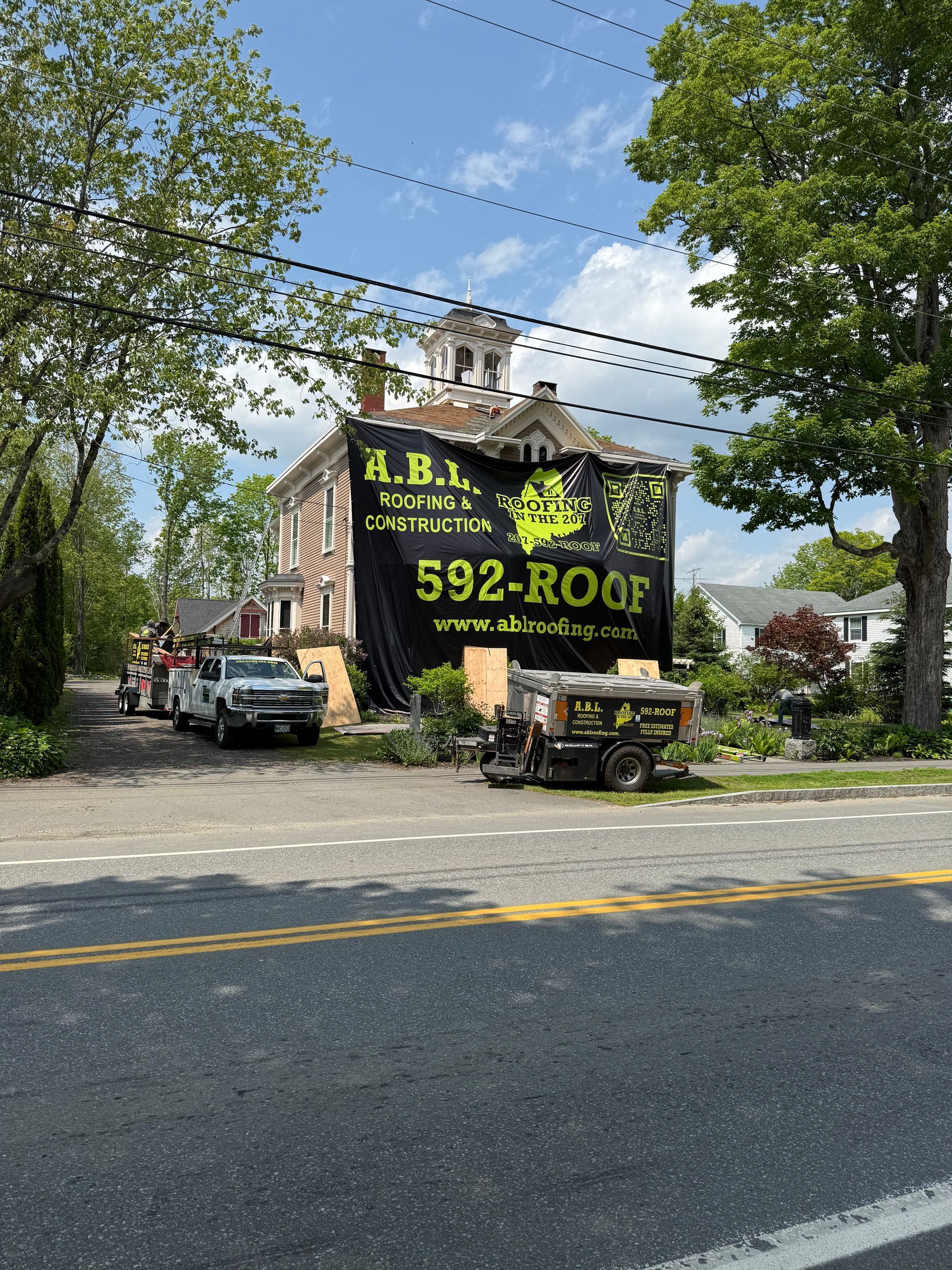 A large billboard on the side of a building says 592-roof