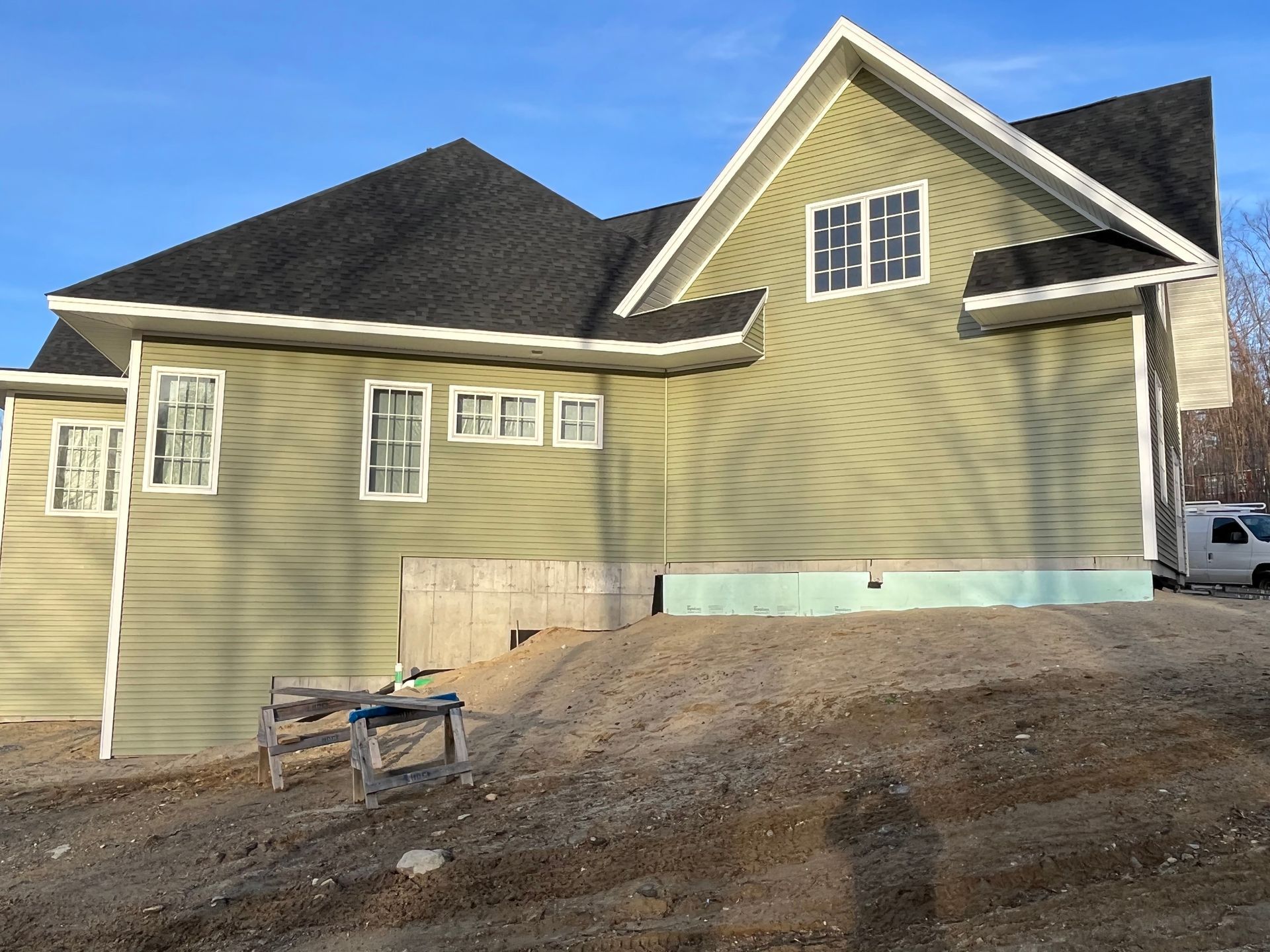 A green house with a black roof is being built