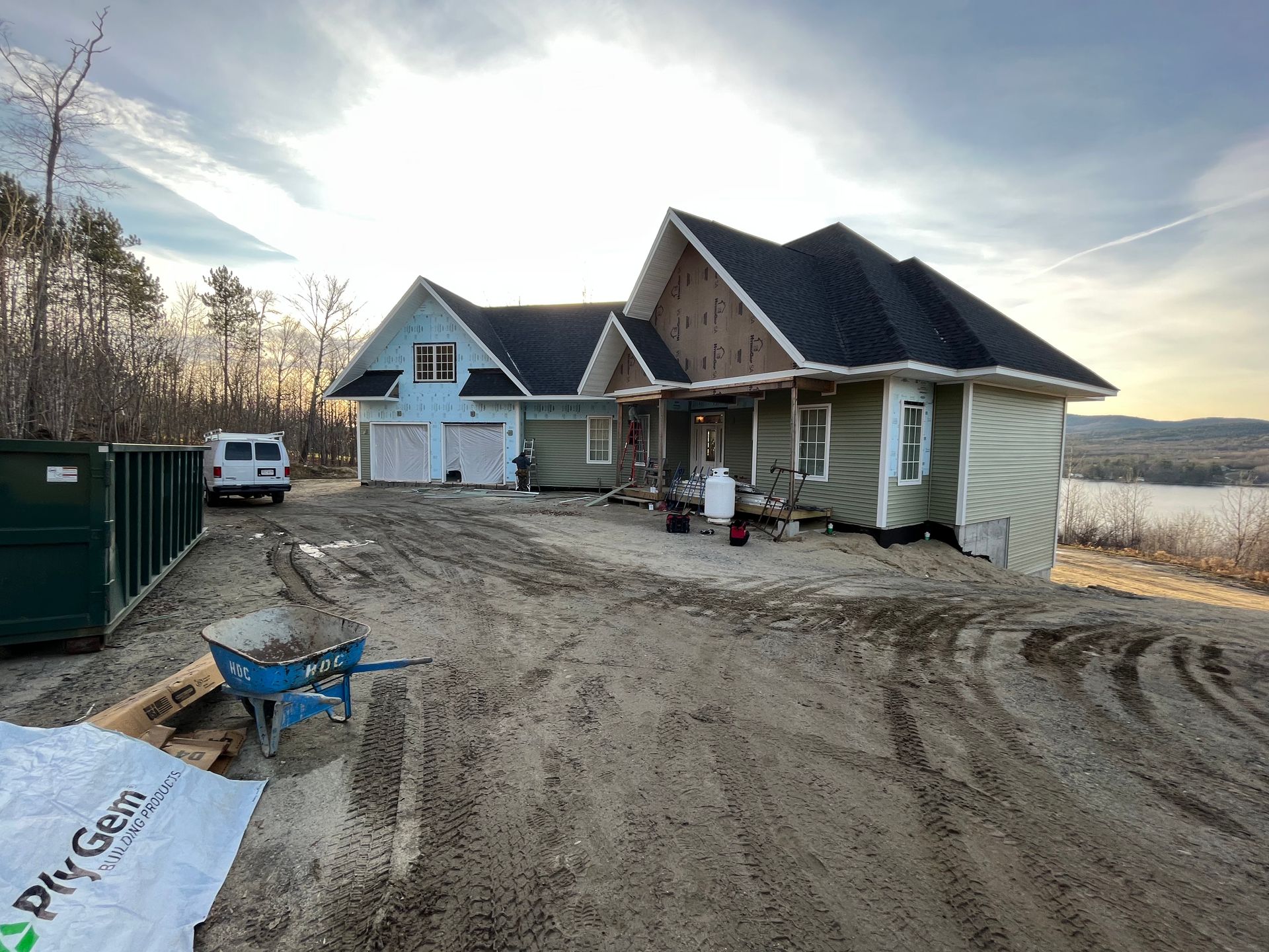 A large house is being built in the middle of a dirt road.
