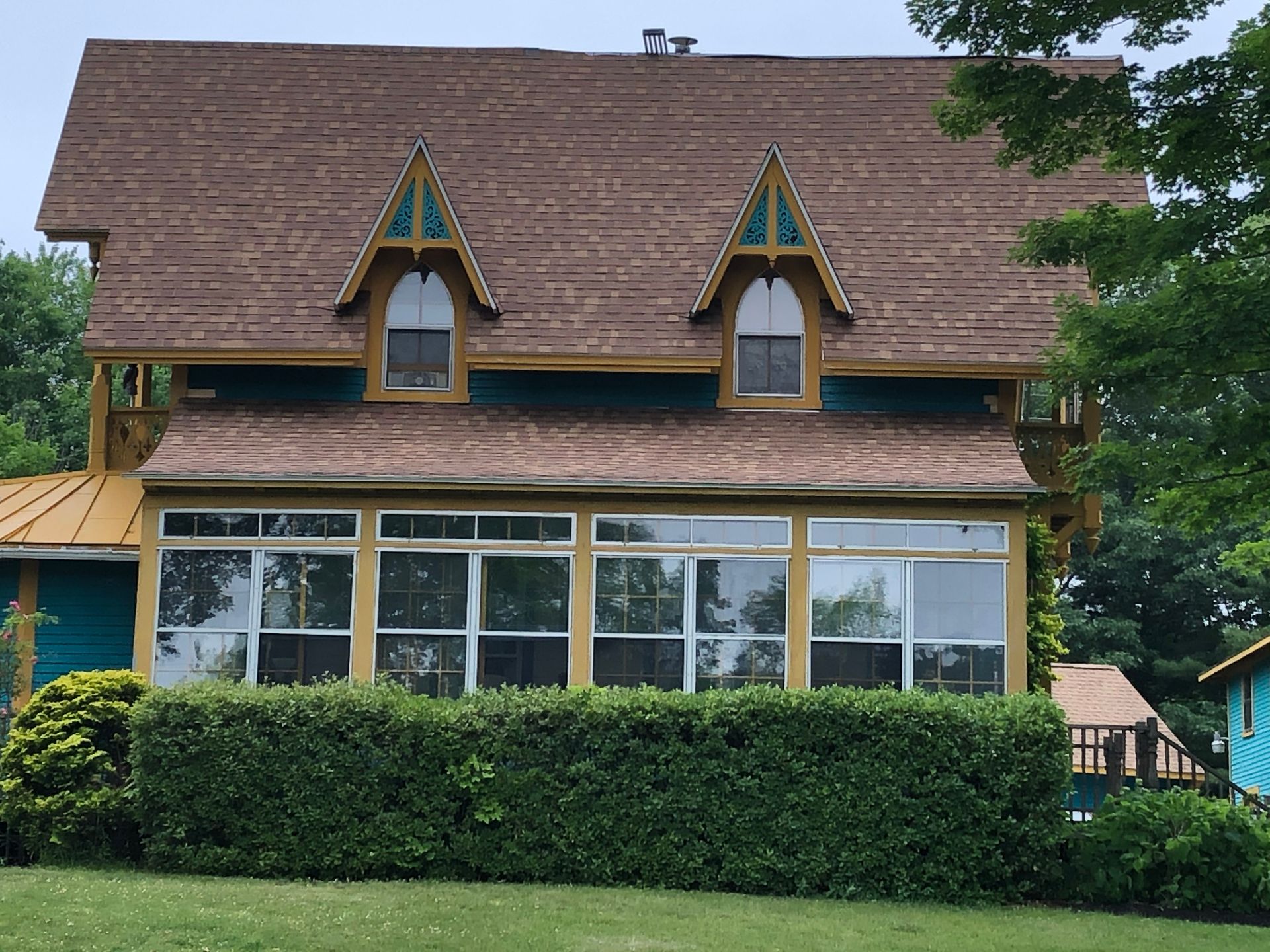 A house with a brown roof and a lot of windows
