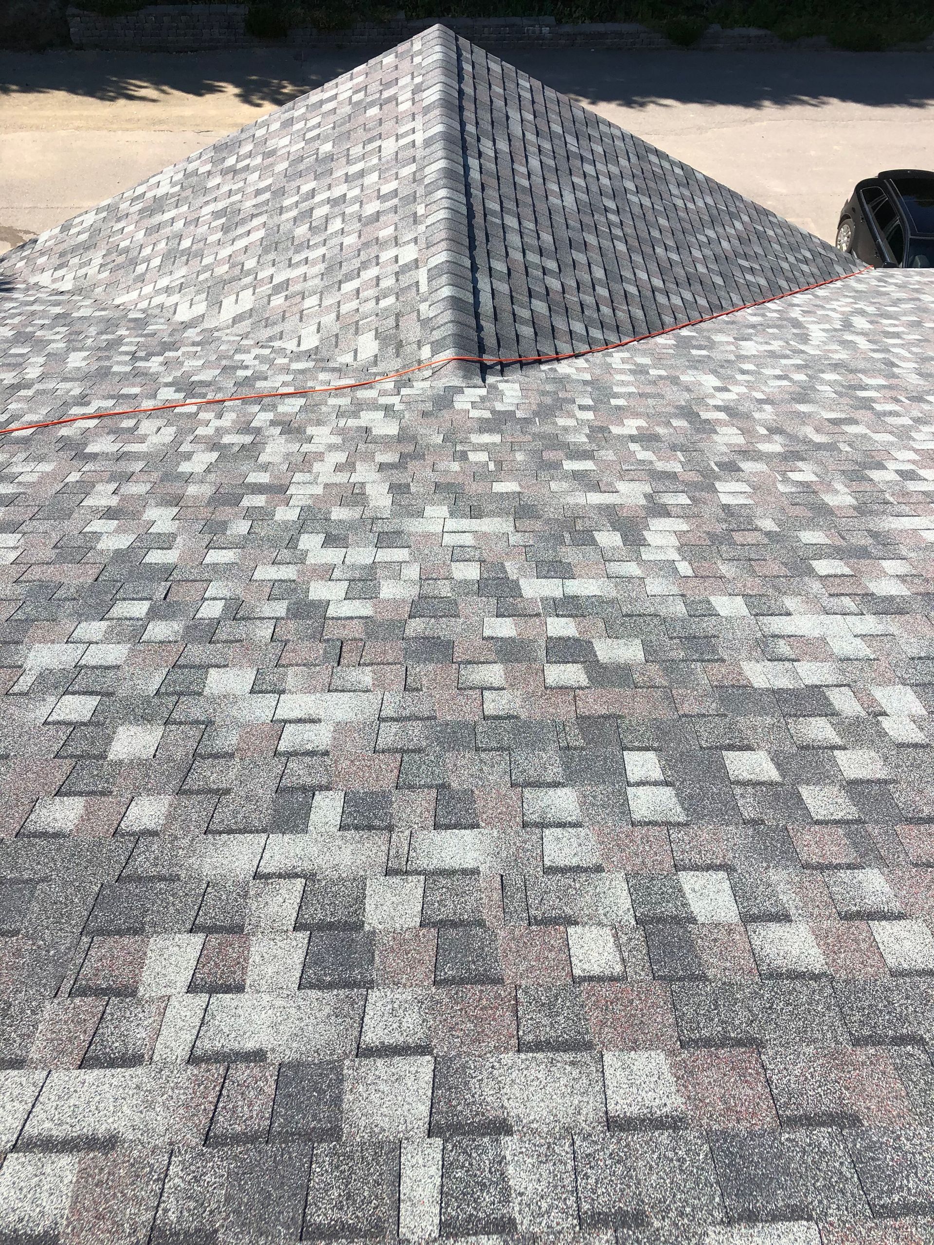 A close up of a roof with shingles that looks like a pyramid.