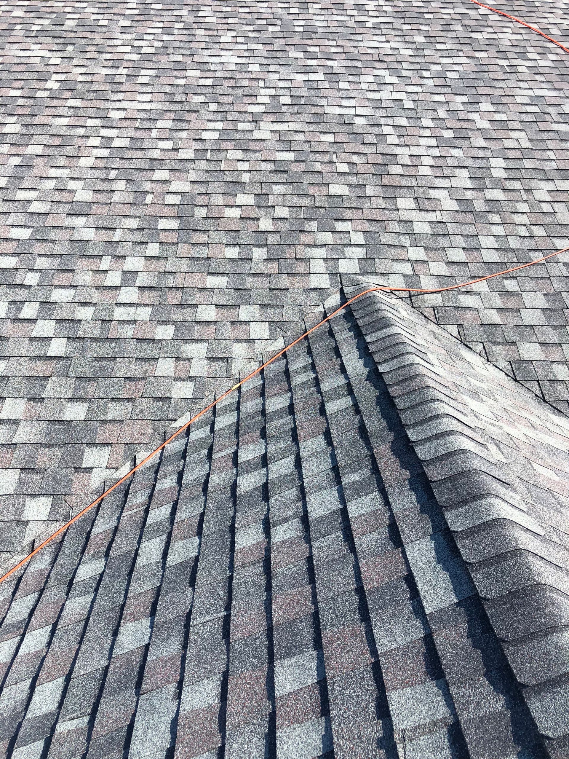 A close up of a roof with shingles on it.