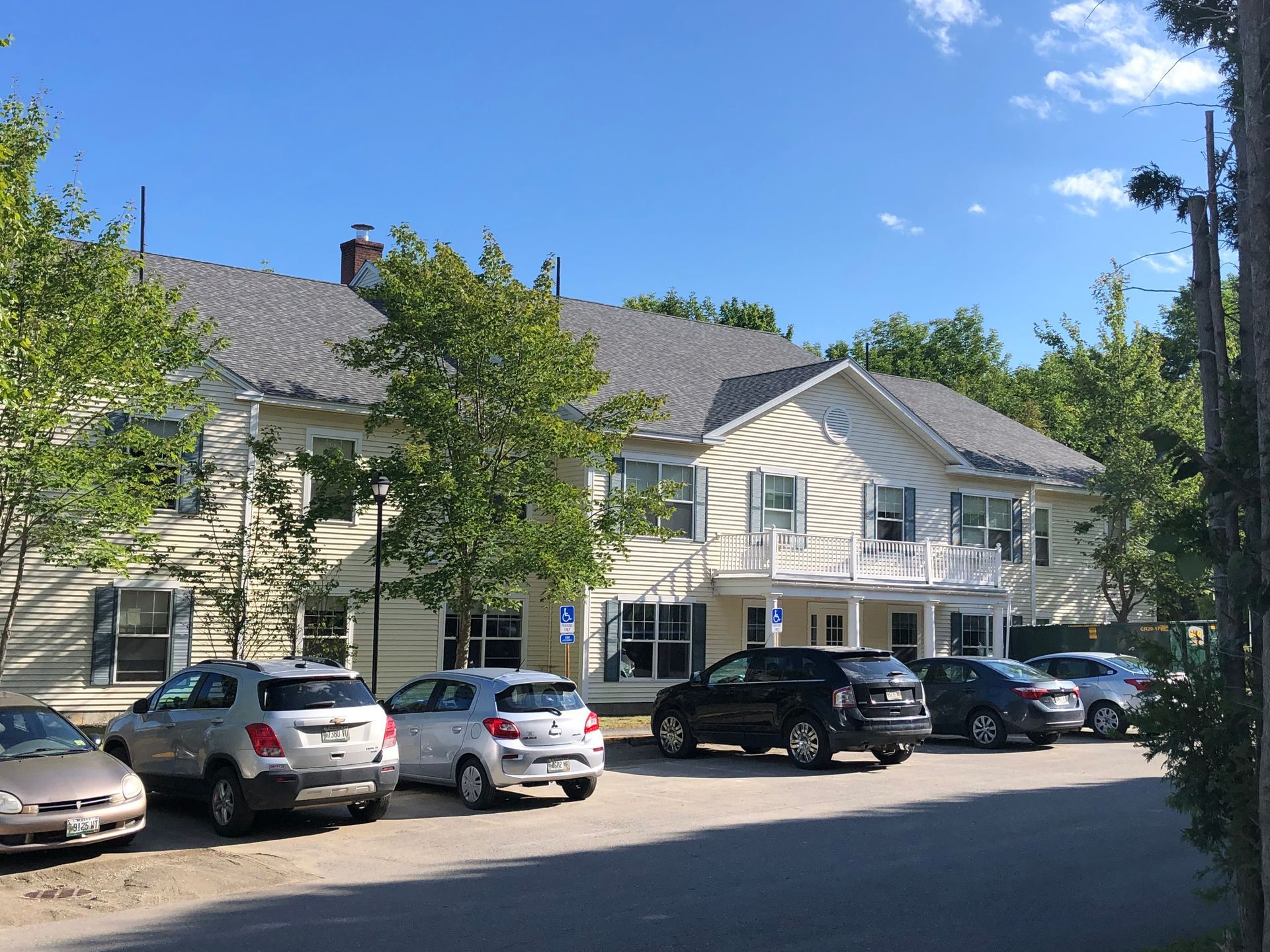 A building with a lot of cars parked in front of it