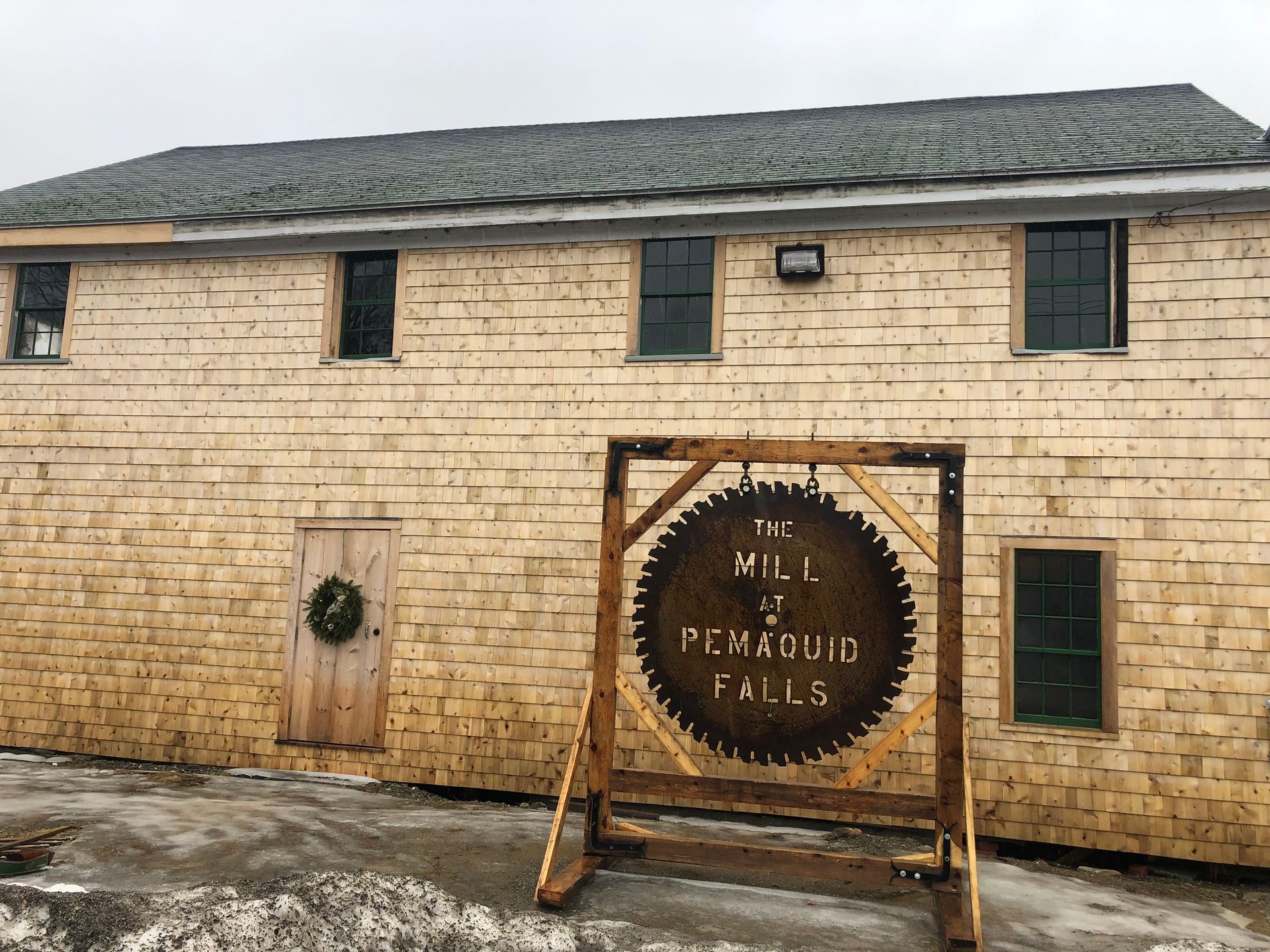 A brick building with a sign on the side that says mill penfolds falls.