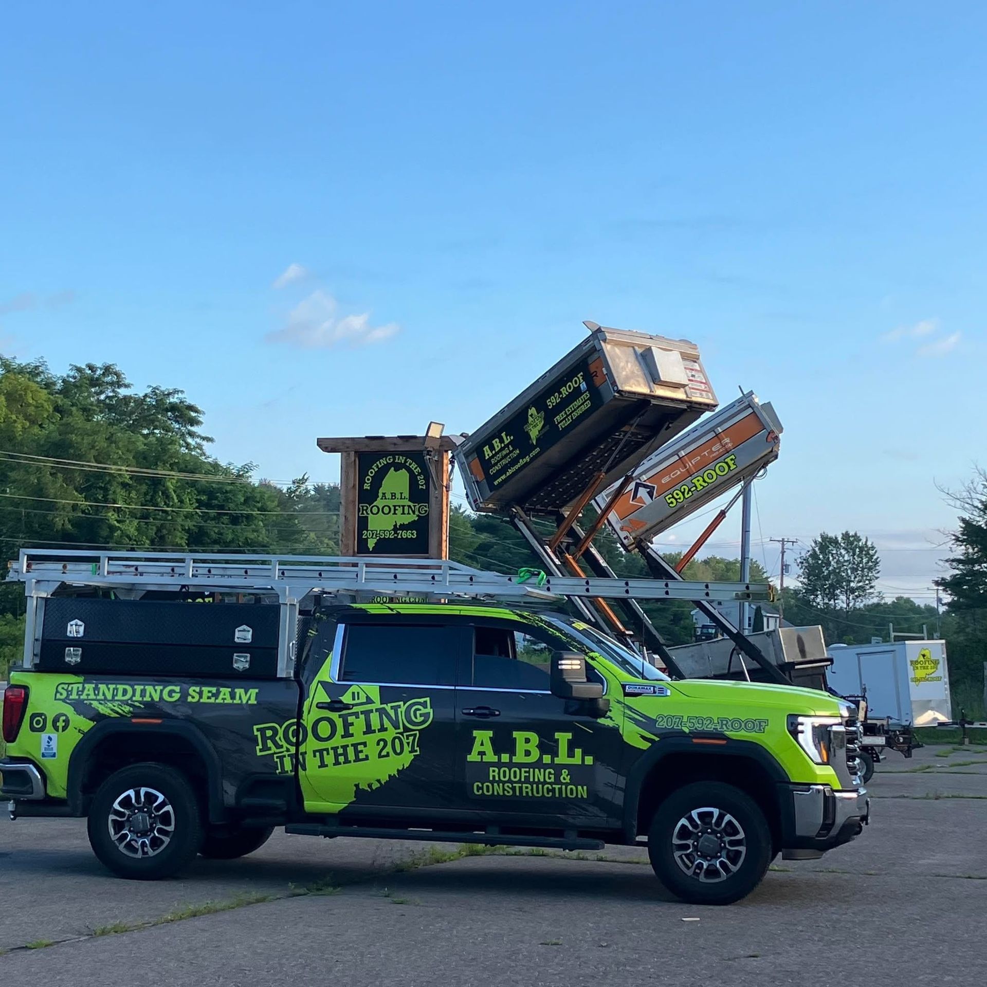 A roofing truck is parked in a parking lot