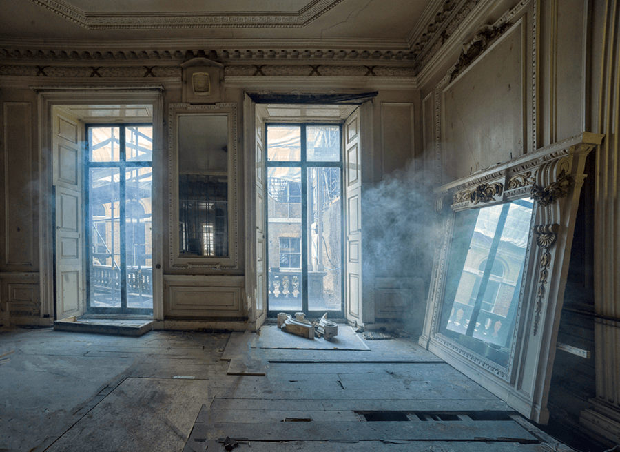 A room with a lot of windows and smoke coming out of the windows.
