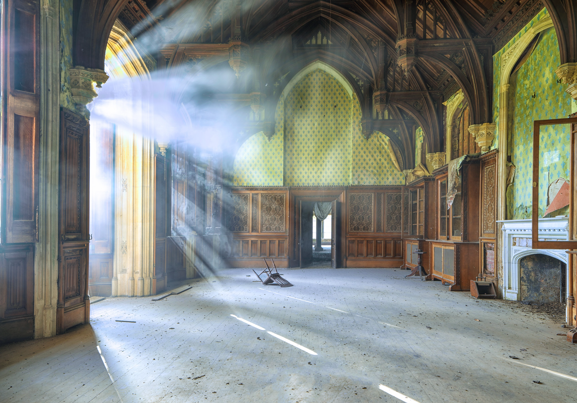 The sun is shining through the windows of an abandoned building