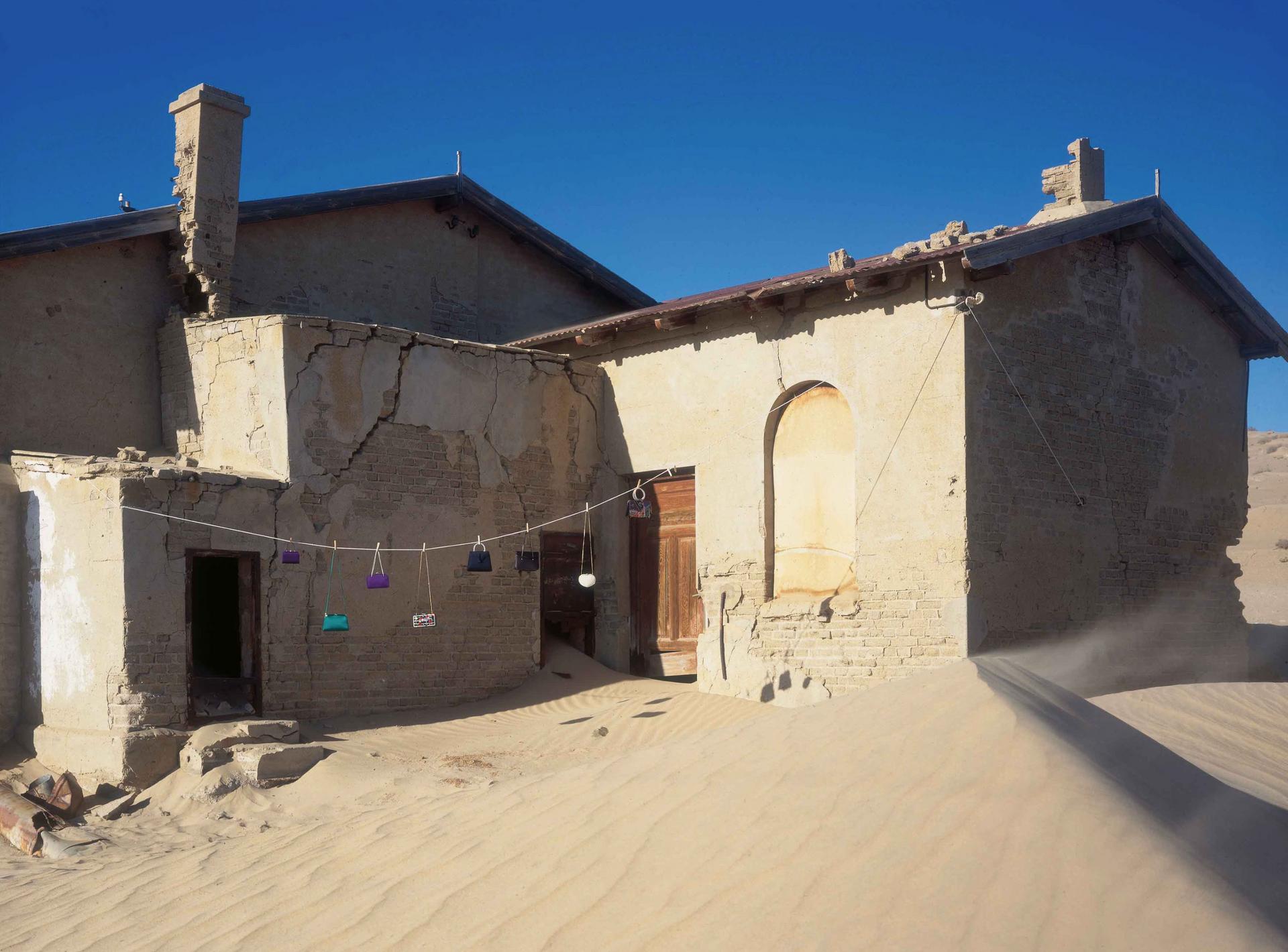 A building in the desert with a chimney on top of it