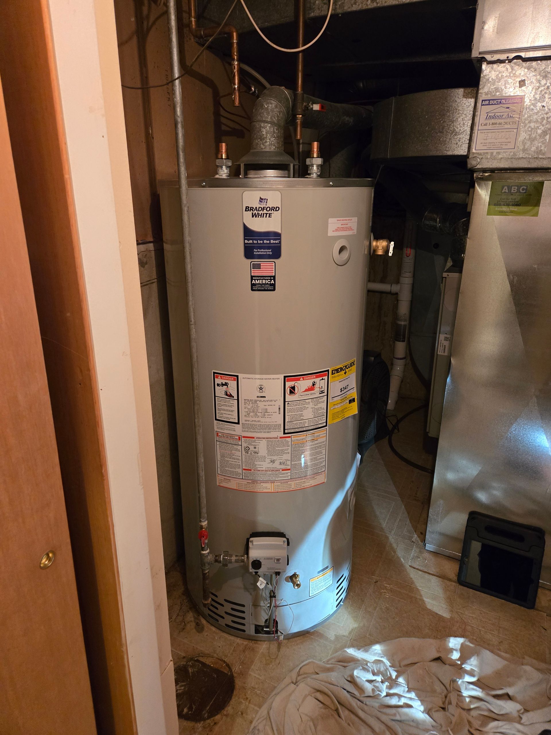 MDM Plumbing & Sewer LLC | A water heater is sitting in the corner of a room.