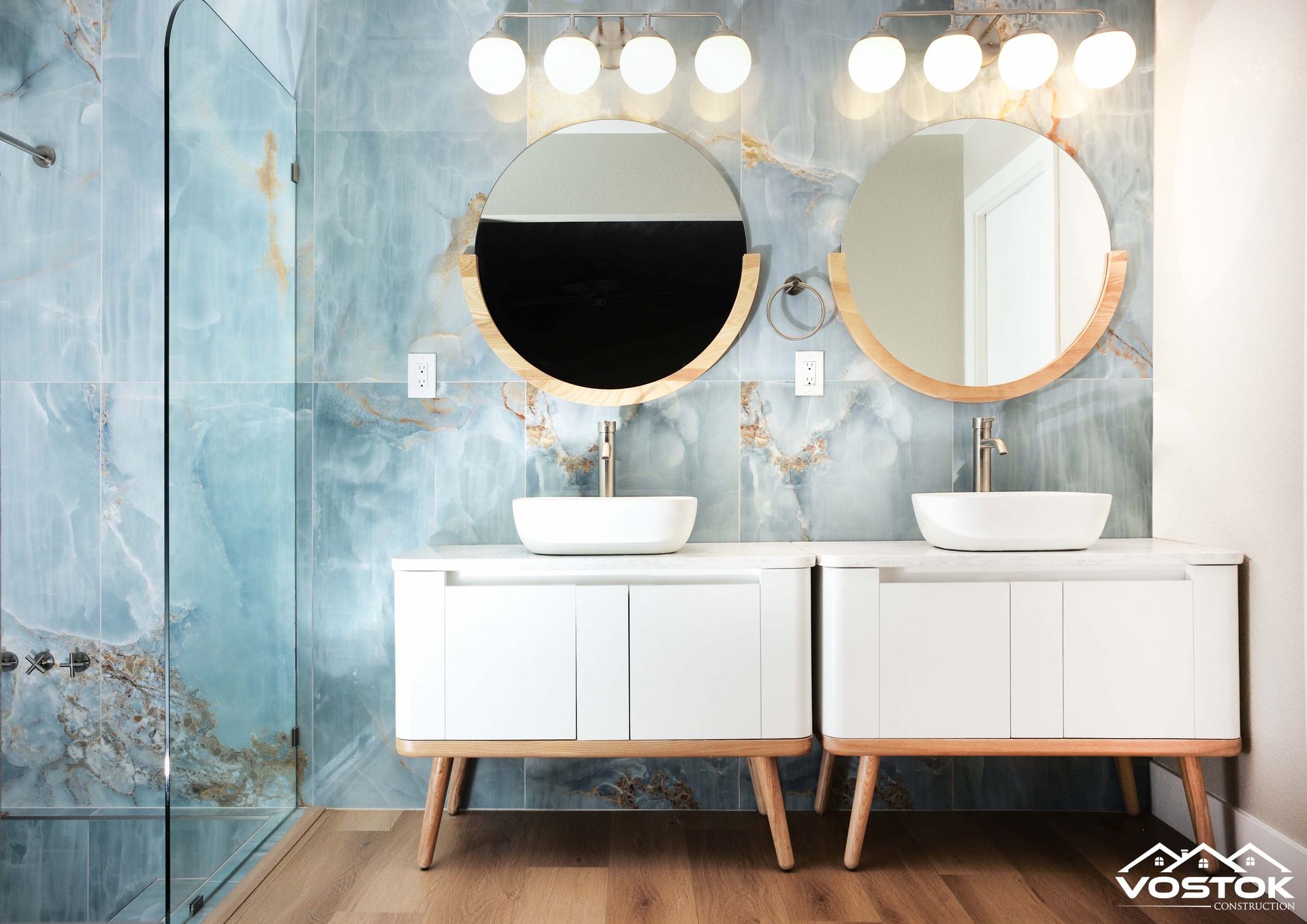 A bathroom with two sinks and two mirrors.