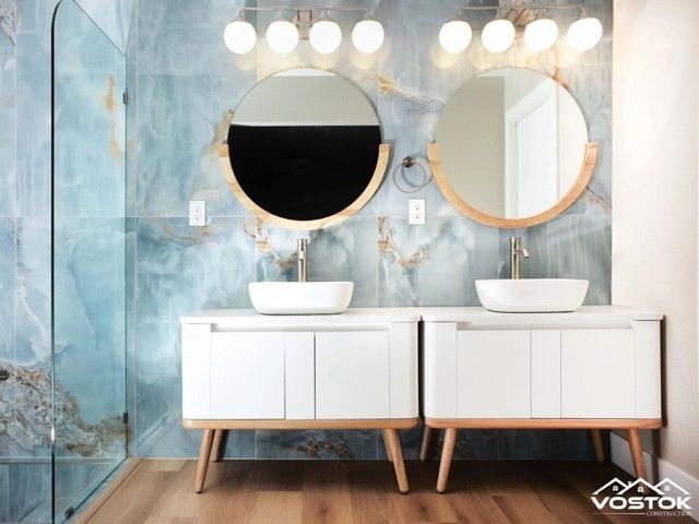 A bathroom with two sinks and two mirrors.