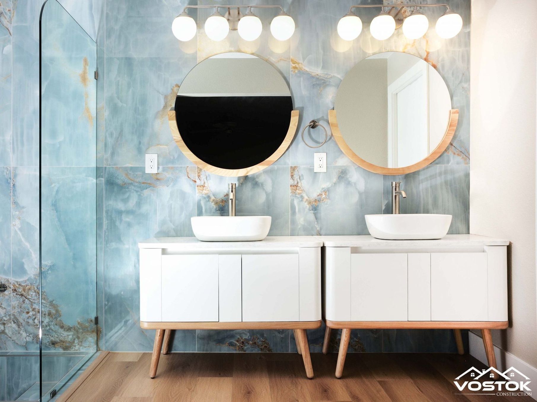 A bathroom with two sinks and two mirrors.