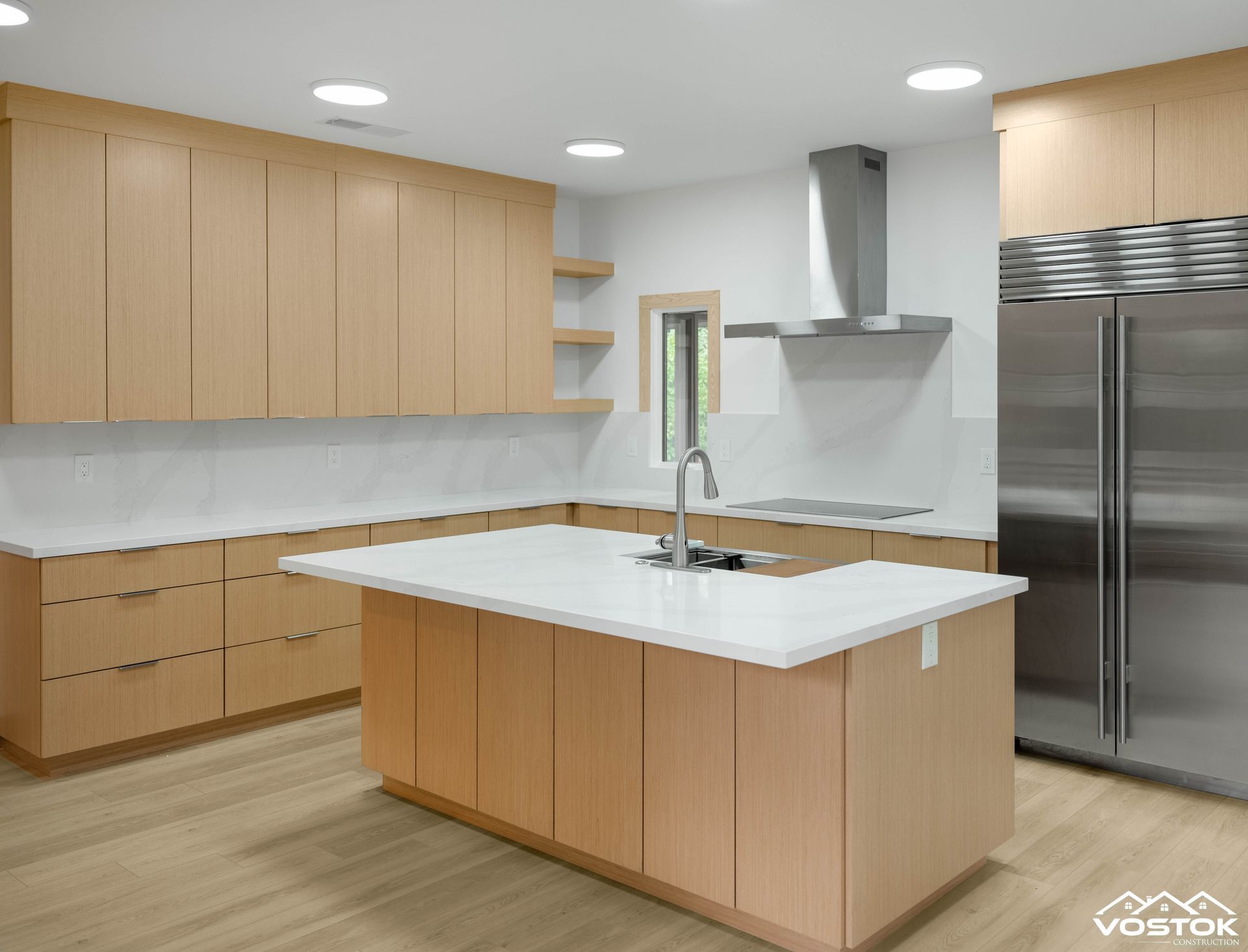 A kitchen with stainless steel appliances and wooden cabinets