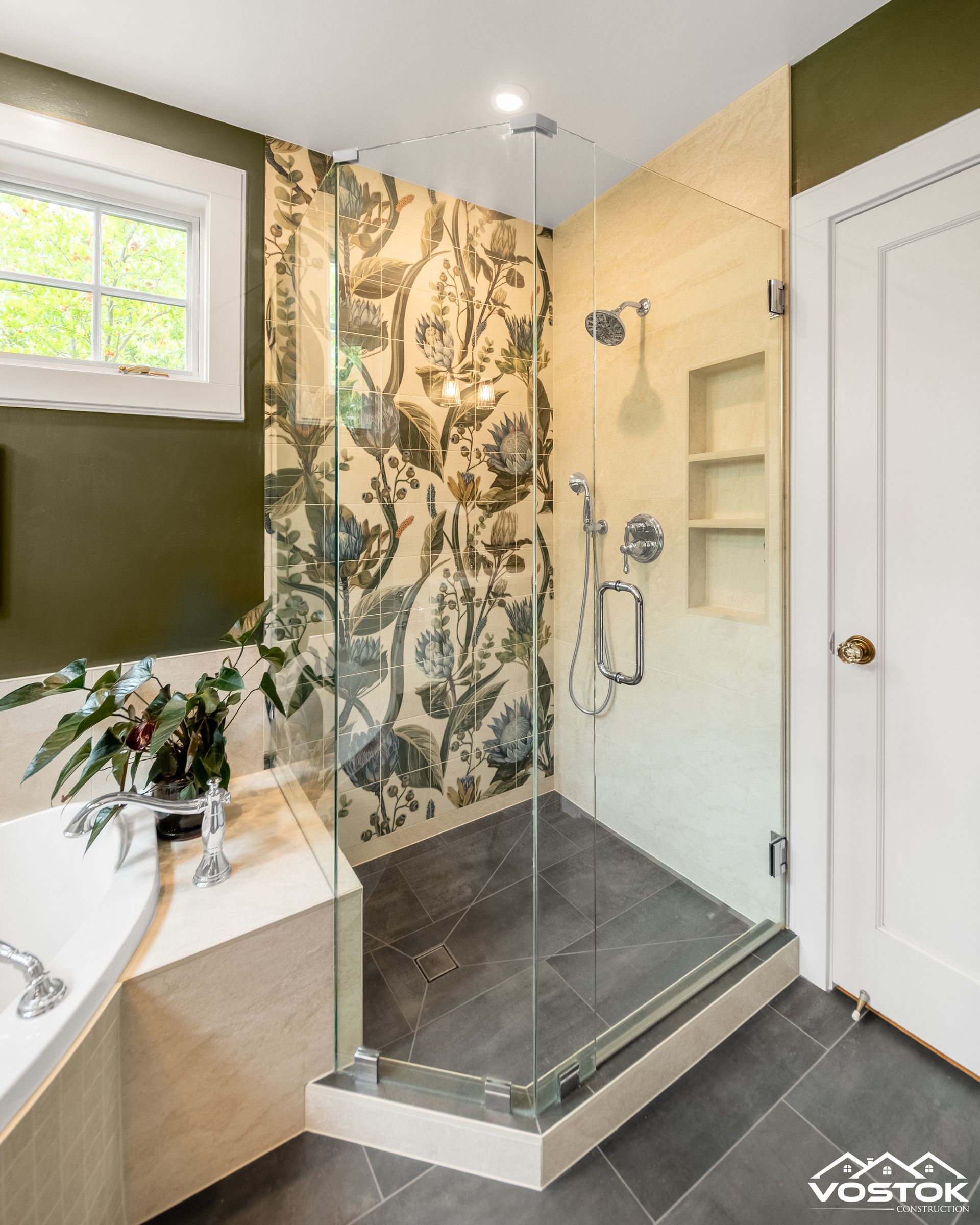 A bathroom with a walk in shower and a bathtub.